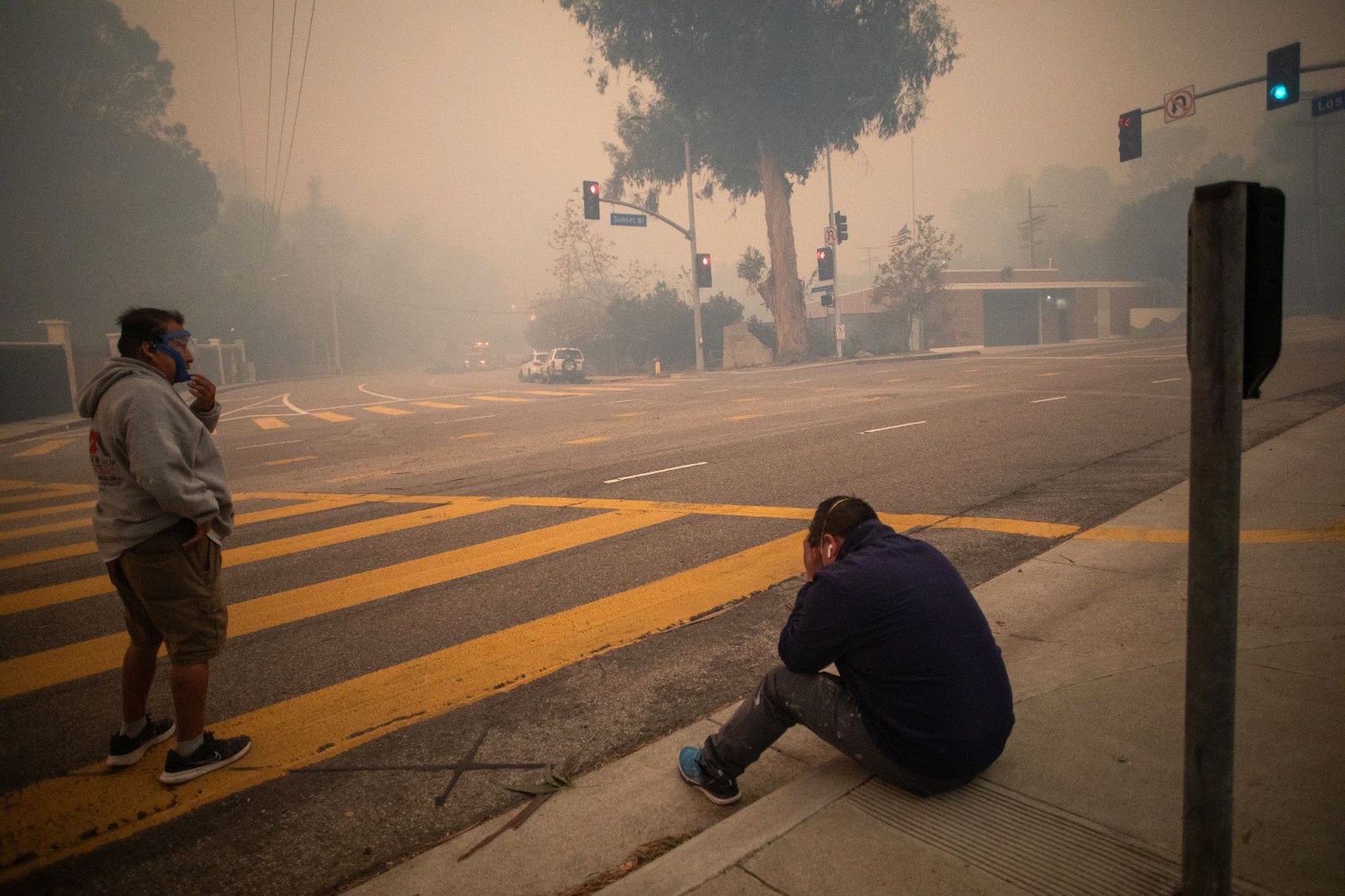 Menschen halten an, um Luft zu holen, während sie während des Palisades-Feuers am 7. Januar 2025 den Sunset Boulevard evakuieren. | Quelle: Getty Images