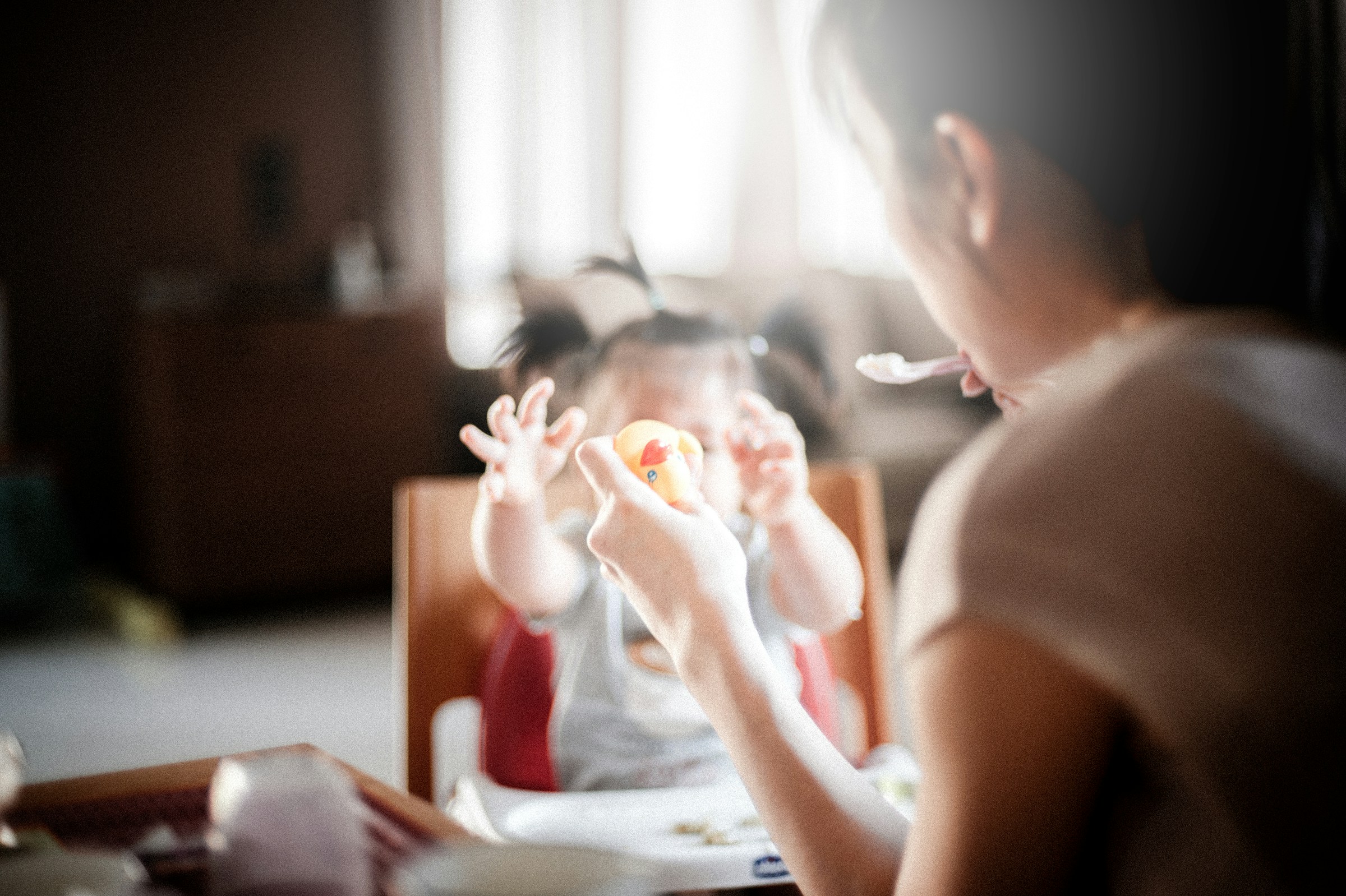 Eine Frau füttert ihre kleine Tochter | Quelle: Unsplash