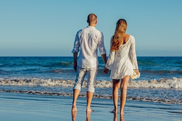 Junges Paar steht sorglos am Strand | Quelle: Pixabay