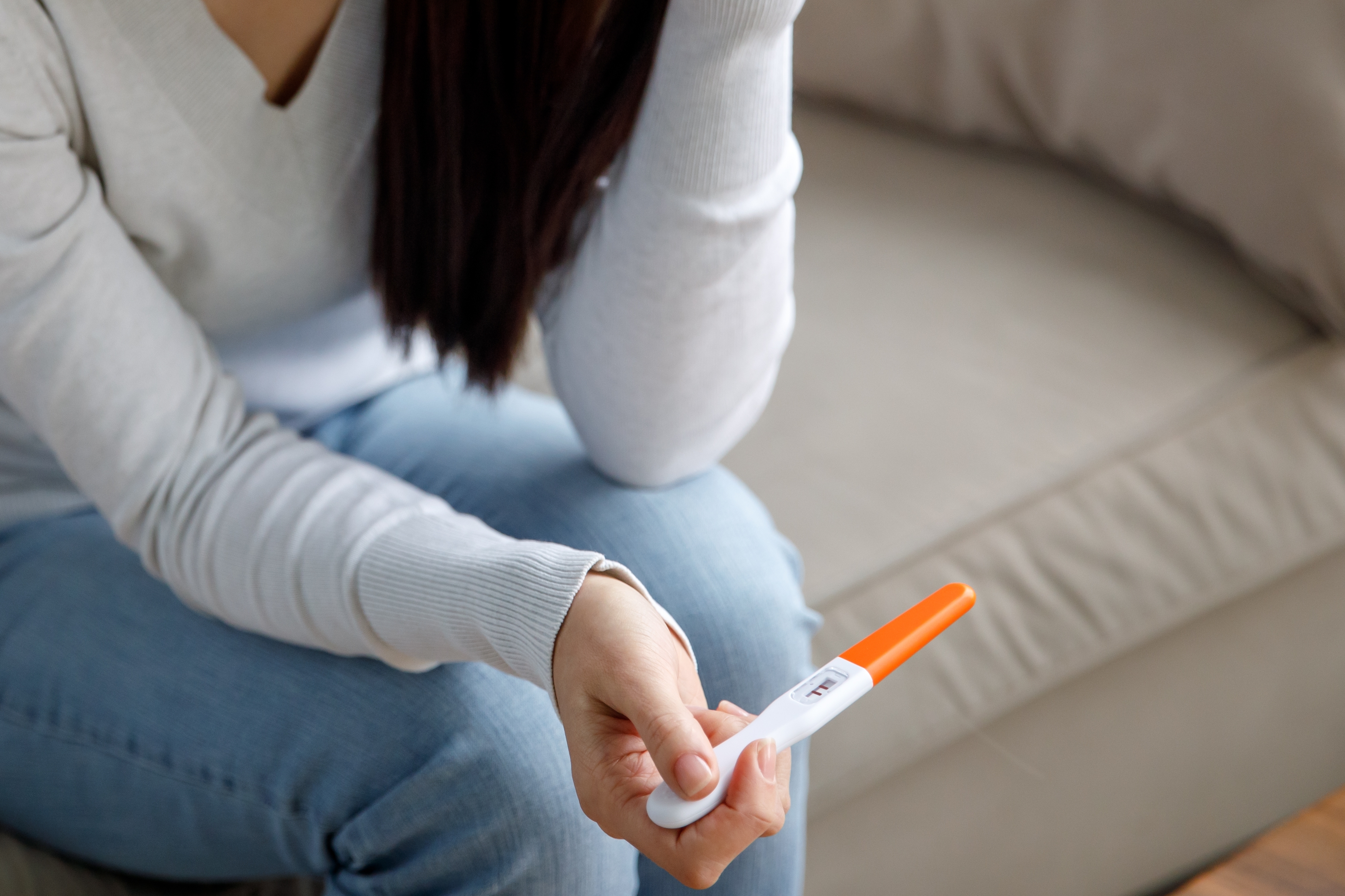 Eine Frau hält einen Schwangerschaftstest in der Hand | Quelle: Shutterstock