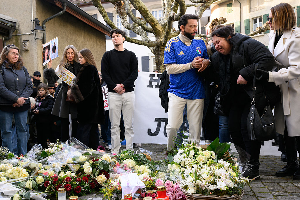 Christian Pidoux (Mitte rechts), Vater des Opfers Trystan, der bei dem Brand ums Leben kam, tröstet die Mutter (Mitte) eines Opfers, während sie an einem Schweigemarsch teilnimmt, der zum Gedenken an einige der Opfer des tödlichen Silvesterbrands in Crans-Montana am 31. Januar 2026 in Lutry bei Lausanne organisiert wurde | Quelle: Getty Images