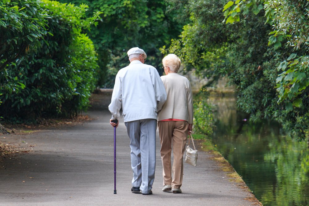 Ein altes Paar beim Spaziergang im Park. | Quelle: Shutterstock