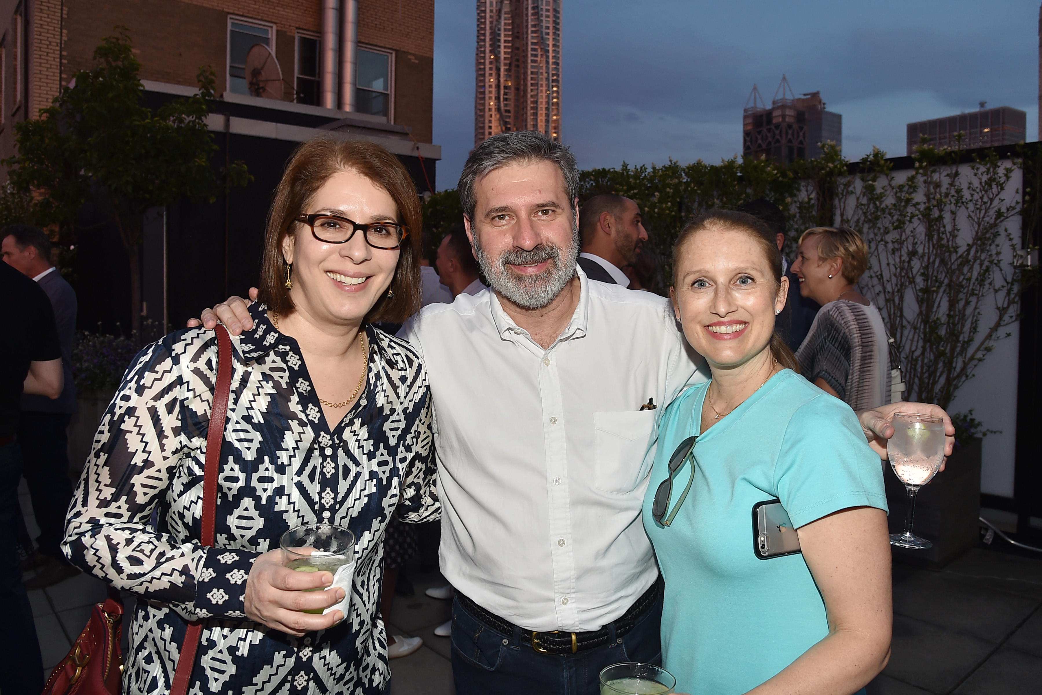 Neda und Christopher Morvillo posieren für ein Foto mit einem Gast namens Leann Graeff bei der Veranstaltung Summer Birthday Cocktails For Lawrence Kaplan in New York City am 21. Juni 2018 | Quelle: Getty Images