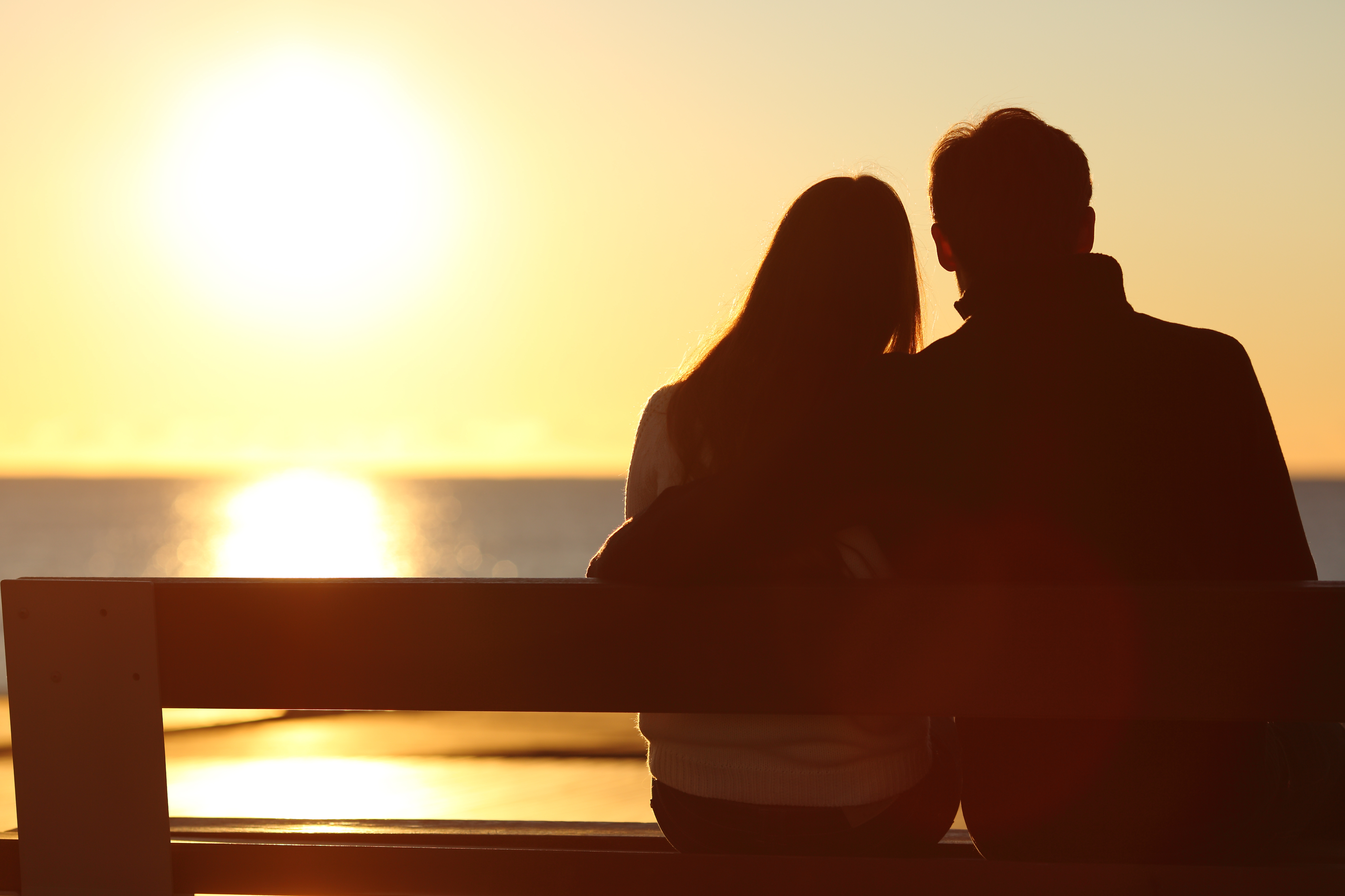 Silhouette eines Paares, das die Sonne am Strand genießt | Quelle: Shutterstock