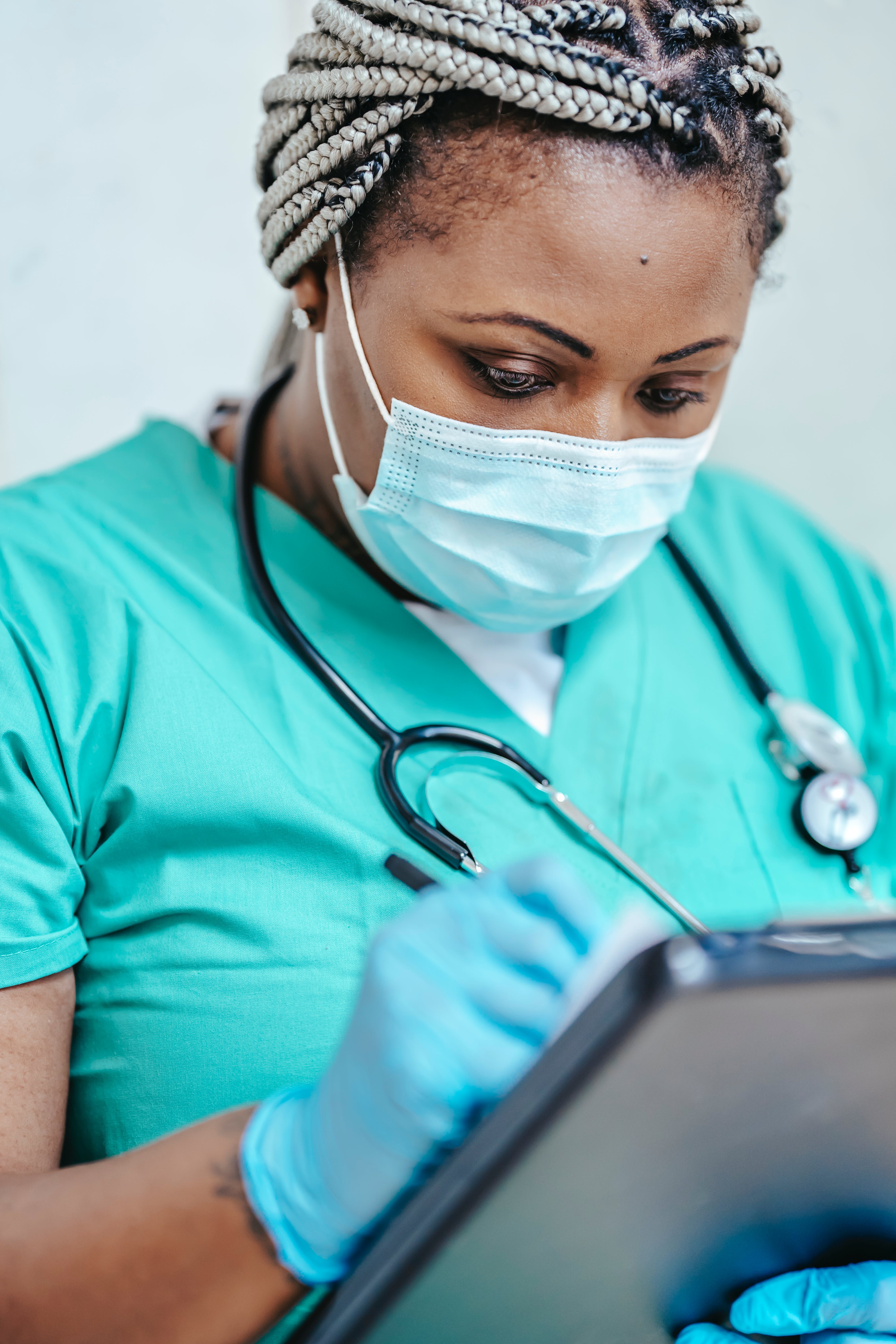 Eine medizinische Fachkraft schaut sich die Krankenakte eines Patienten an | Quelle: Pexels