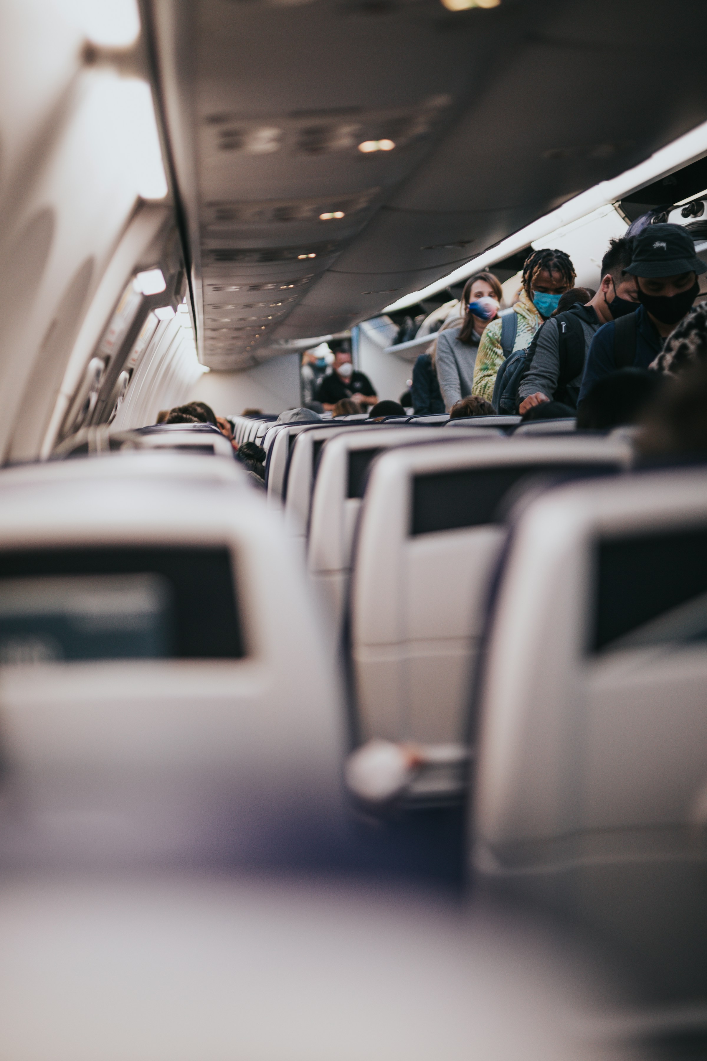 Menschen nehmen ihre Plätze in einem Flugzeug ein | Quelle: Unsplash