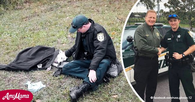 Ein Polizist bleibt stehen, um einen Hund zu trösten, der fast von einem Auto überfahren wurde, und gibt ihm seine Jacke