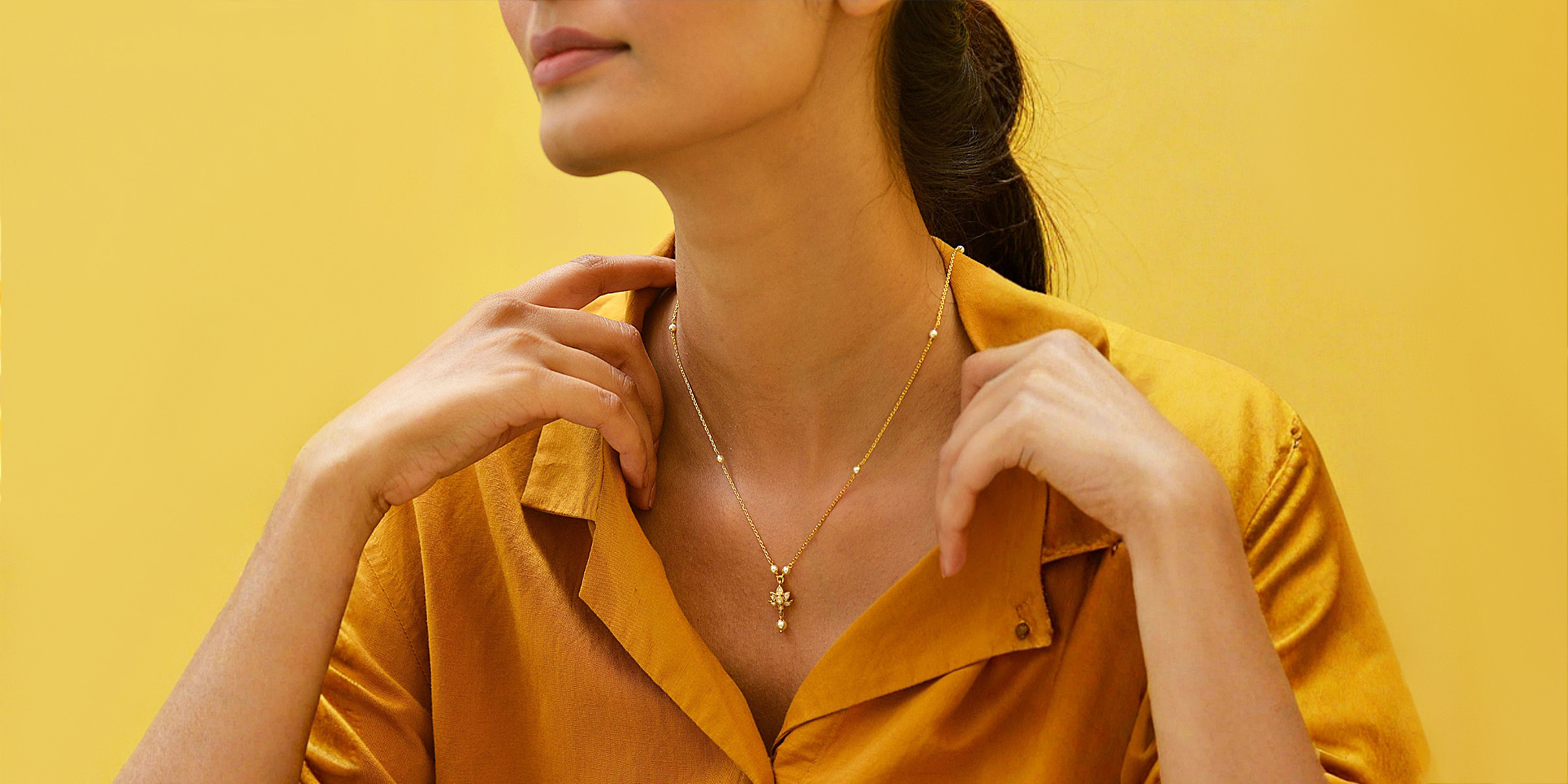 Eine Frau trägt eine goldene Halskette | Quelle: Pexels