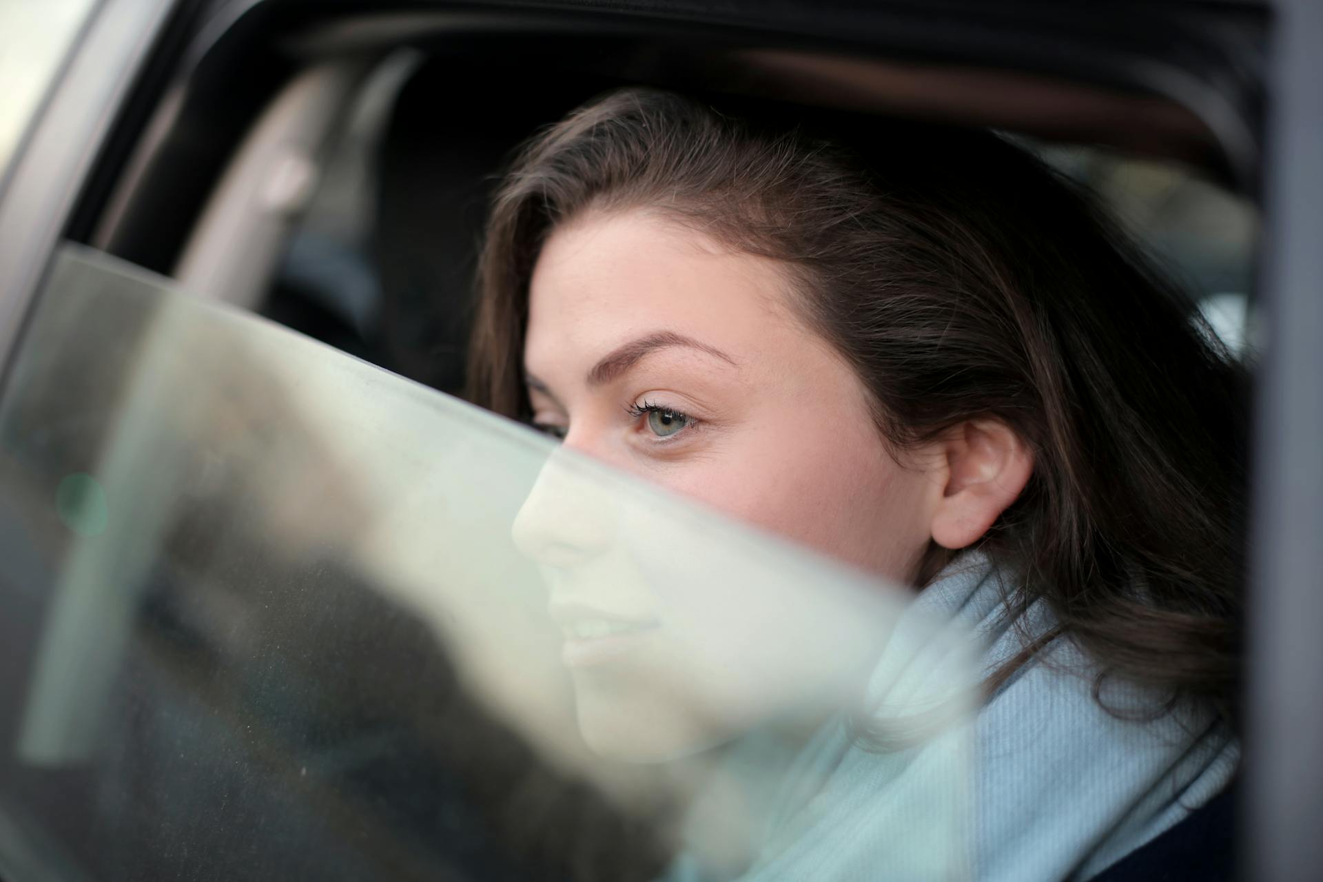 Eine Frau schaut aus dem Autofenster | Quelle: Pexels