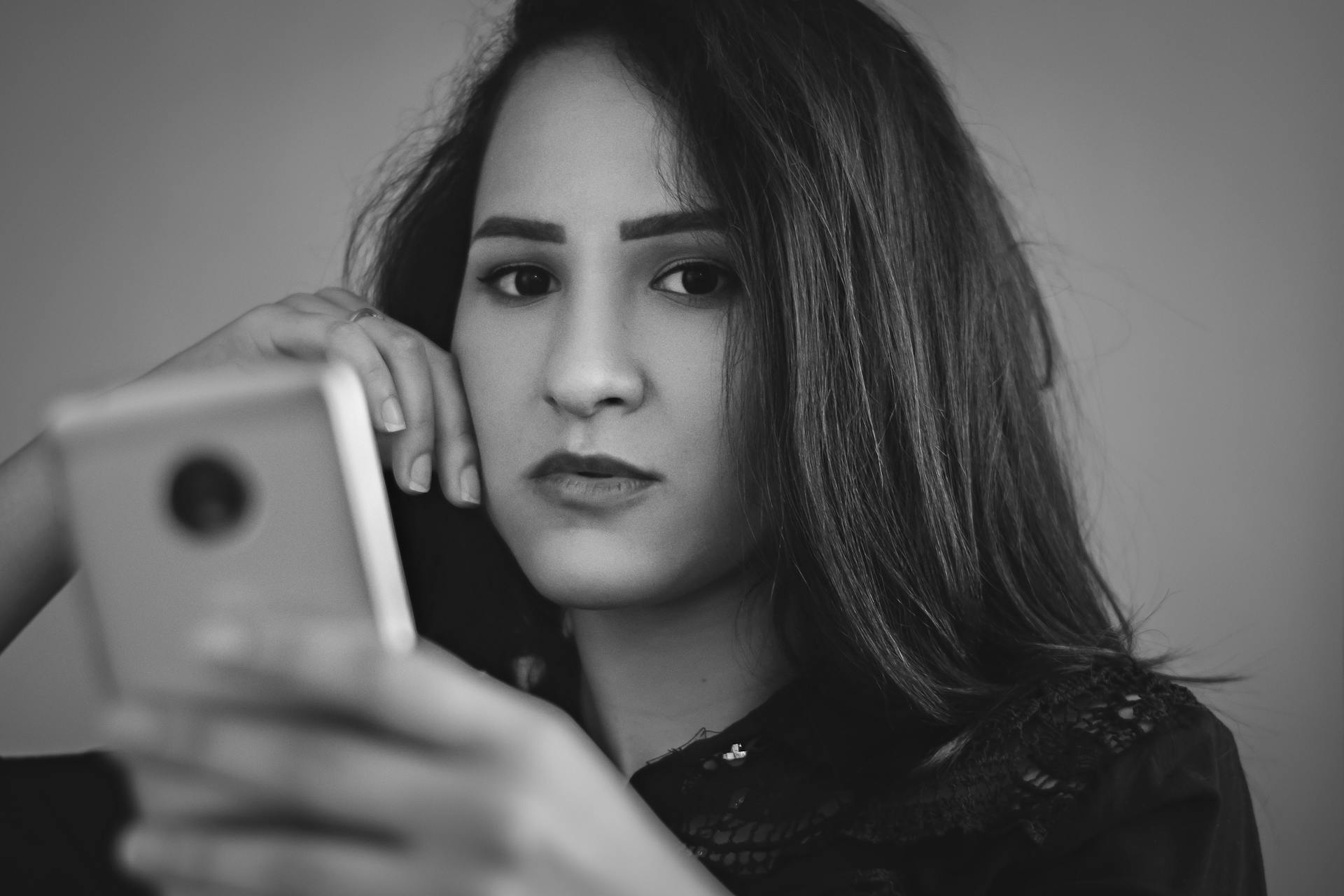 Eine uninteressierte Frau, die ein Telefon hält | Quelle: Pexels
