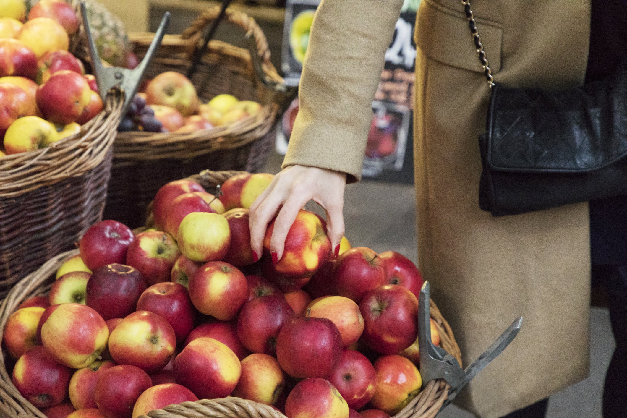Nahaufnahme der weiblichen Hand, die Äpfel am Markt holt | Quelle: Getty Images