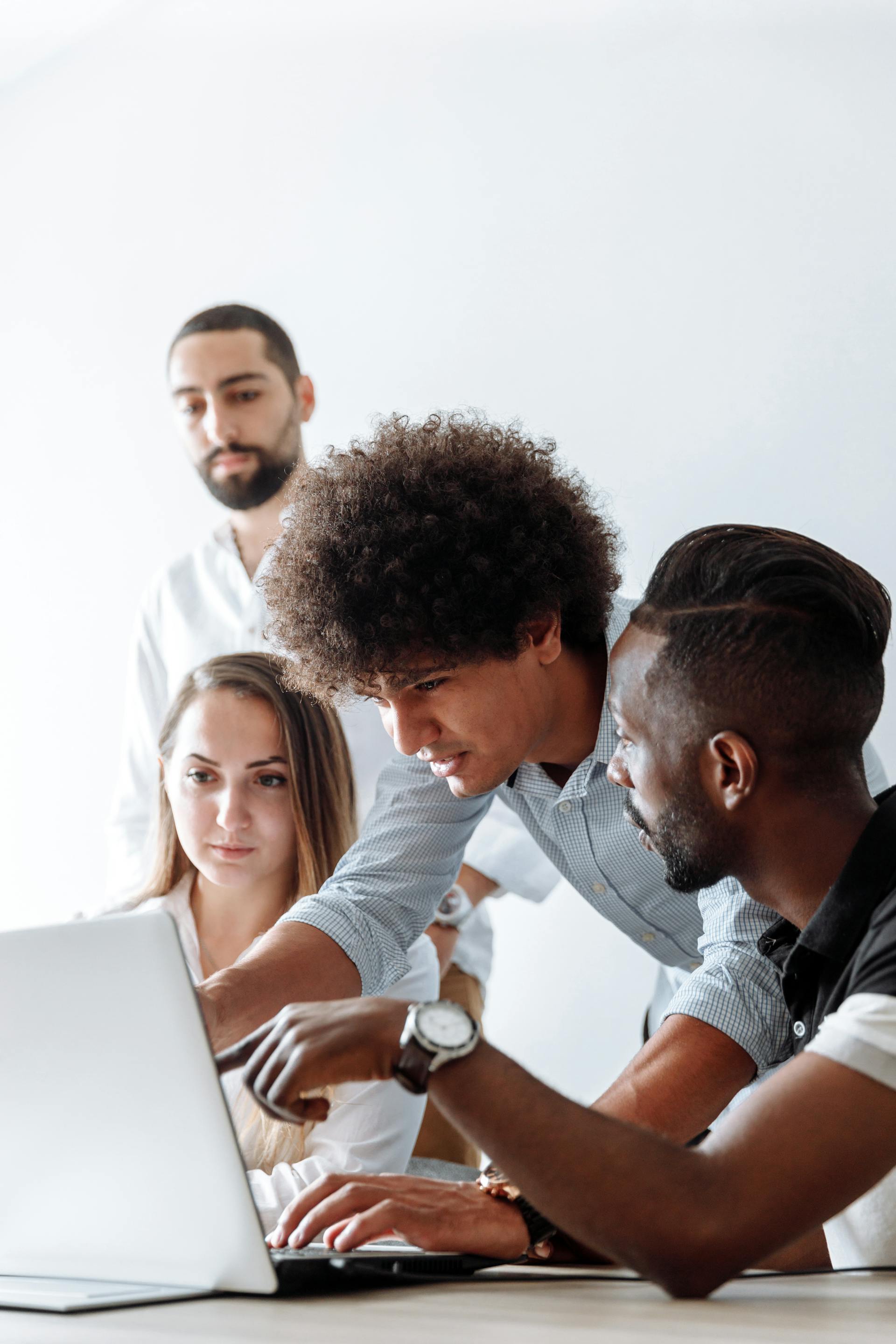 Menschen, die etwas auf einem Laptop diskutieren | Quelle: Pexels
