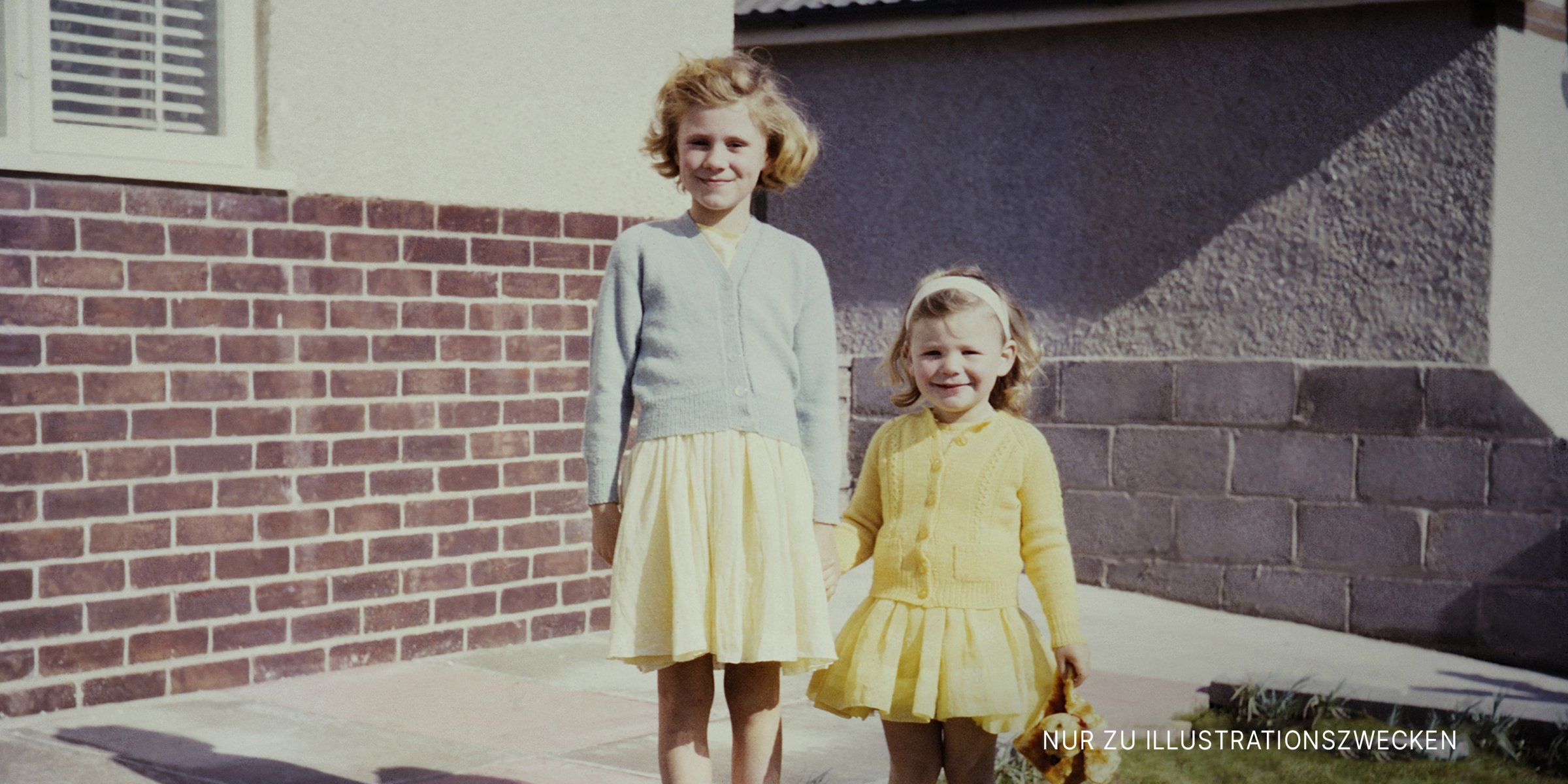Zwei Mädchen lächeln beim Posieren für ein Foto. | Quelle: Getty Images