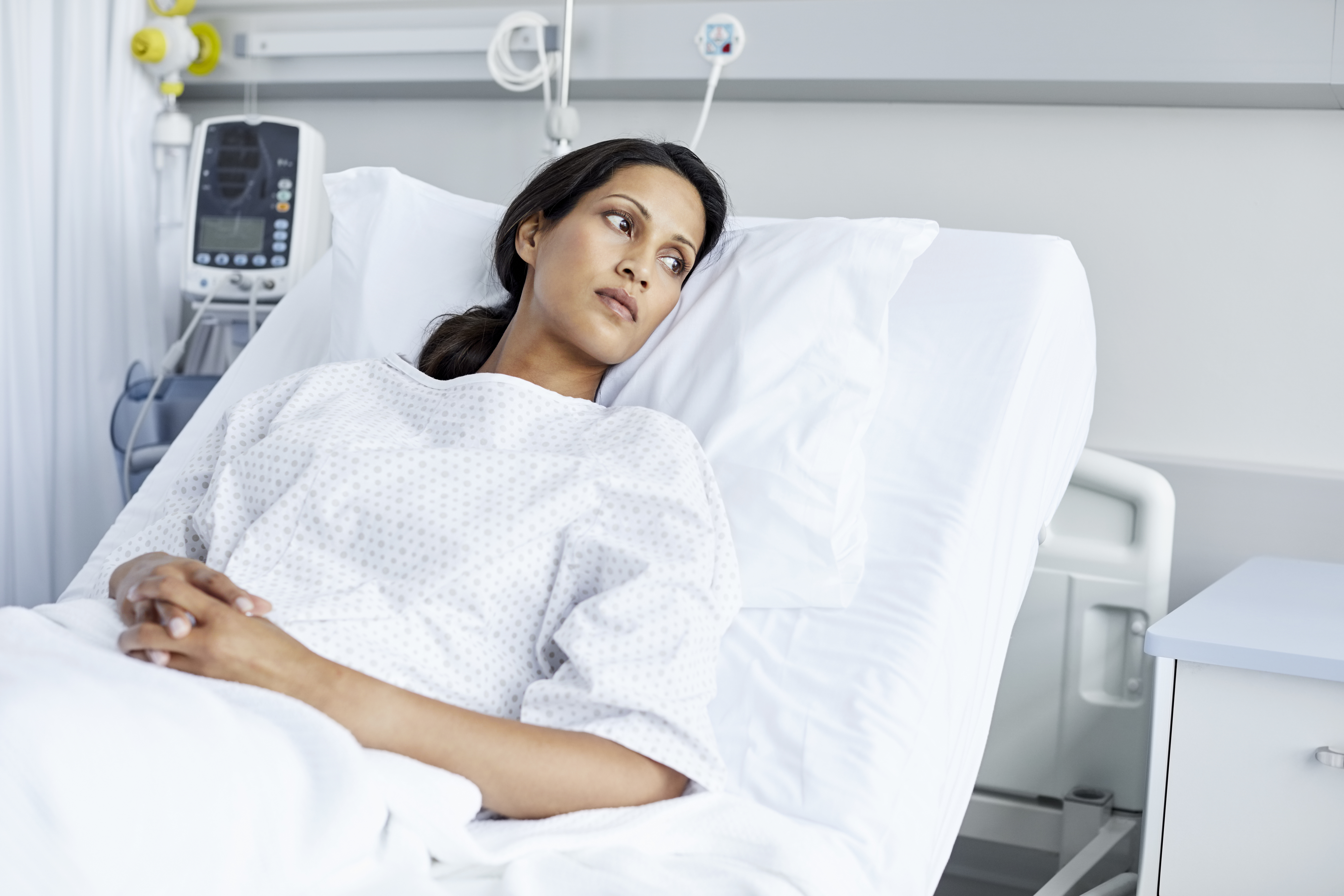 Eine unglückliche Frau in einem Krankenhausbett | Quelle: Getty Images