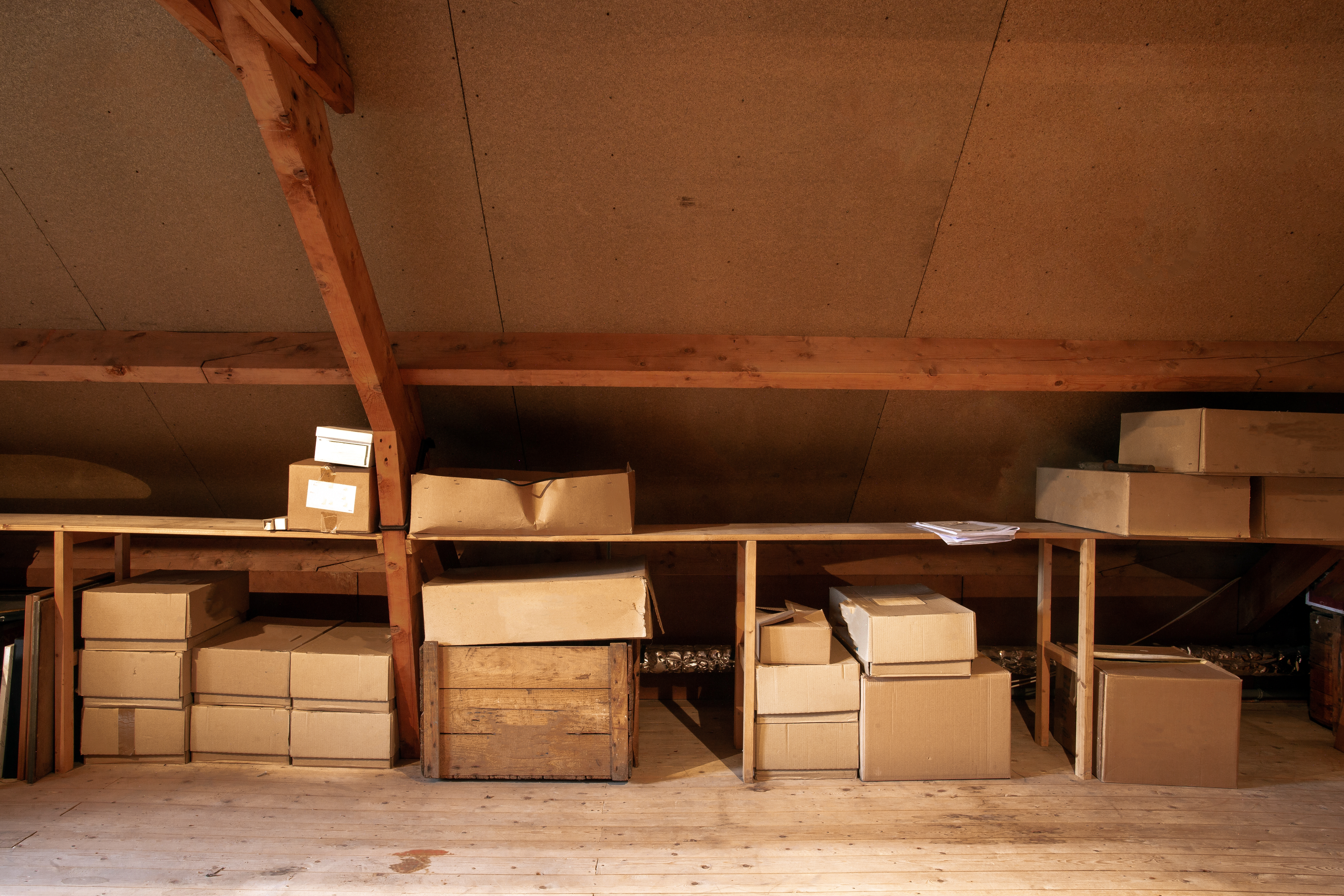 Ein alter hölzerner Dachboden mit alten Pappkartons zur Lagerung | Quelle: Shutterstock