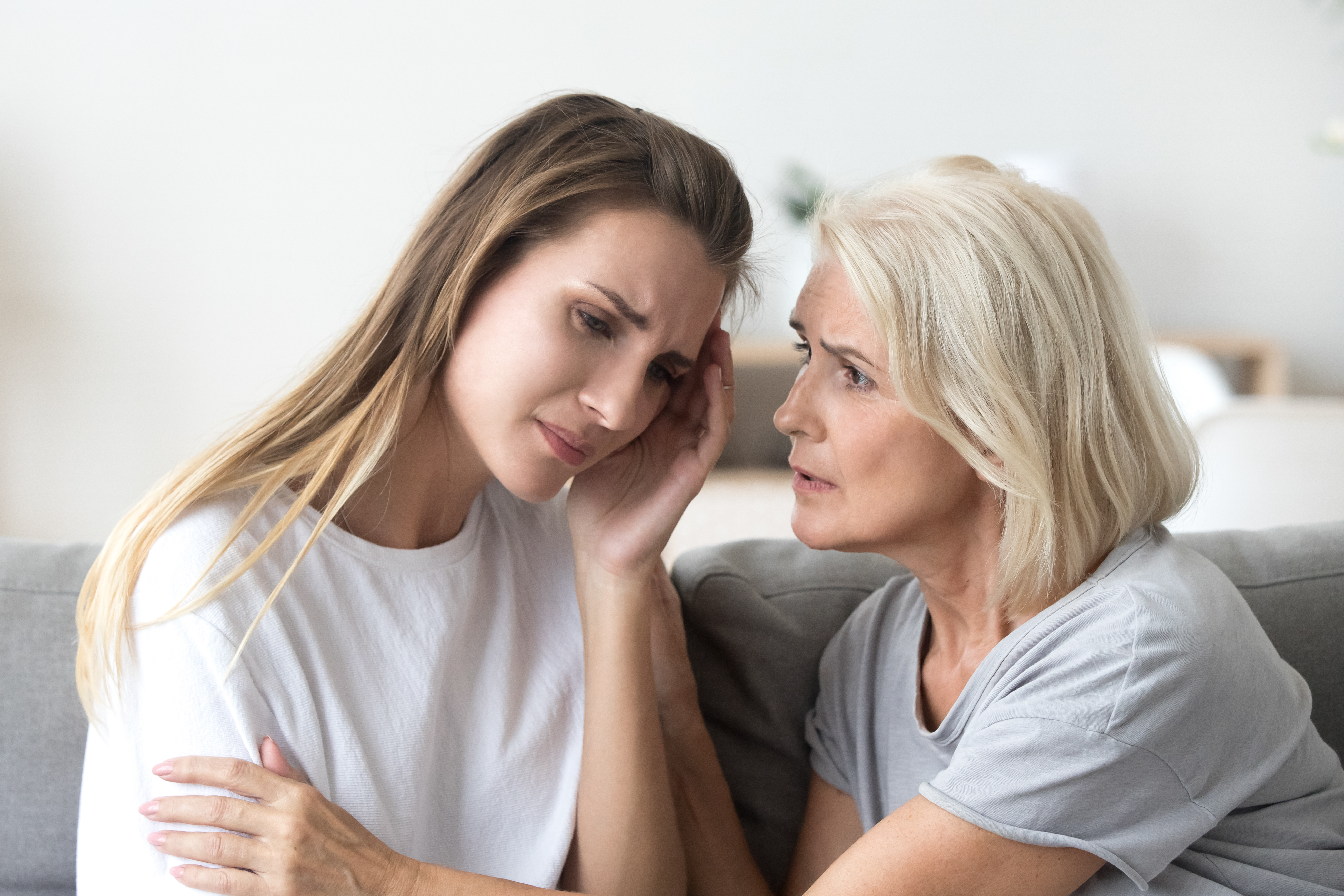 Eine ältere Frau tröstet eine besorgte jüngere Frau | Quelle: Shutterstock