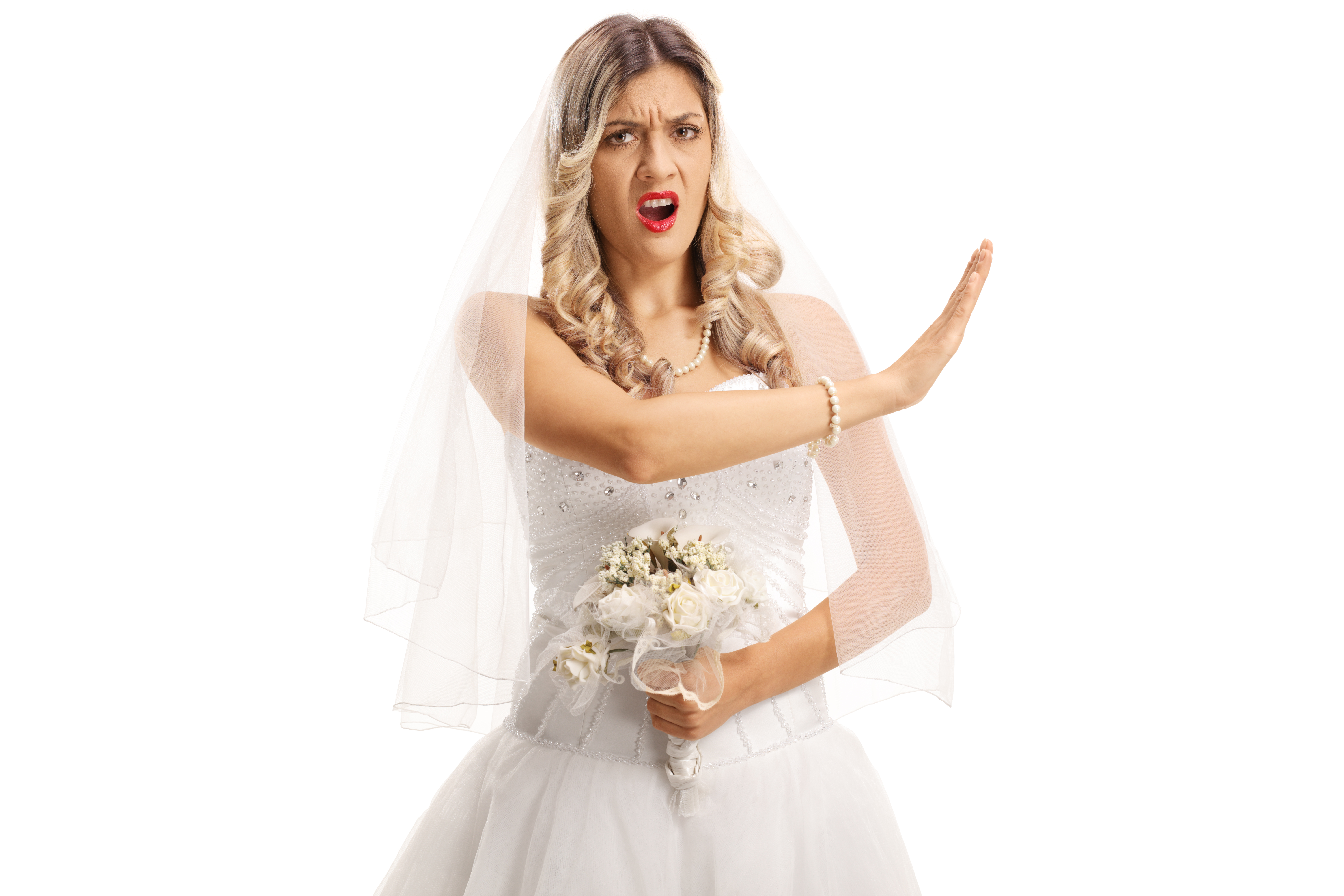 Eine wütende Braut in ihrer Hochzeitskleidung gestikuliert mit ihrer Hand | Quelle: Shutterstock