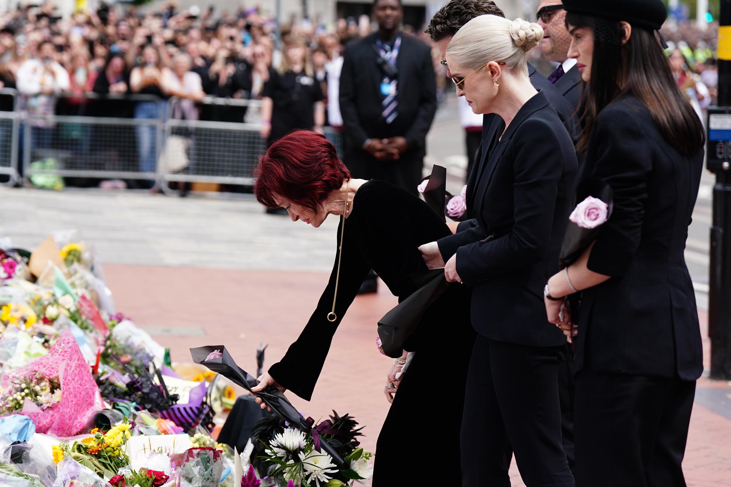 Die Familie Osbourne betrachtet die Nachrichten und Blumen an der Black Sabbath Bridge in Birmingham am 30. Juli 2025 | Quelle: Getty Images