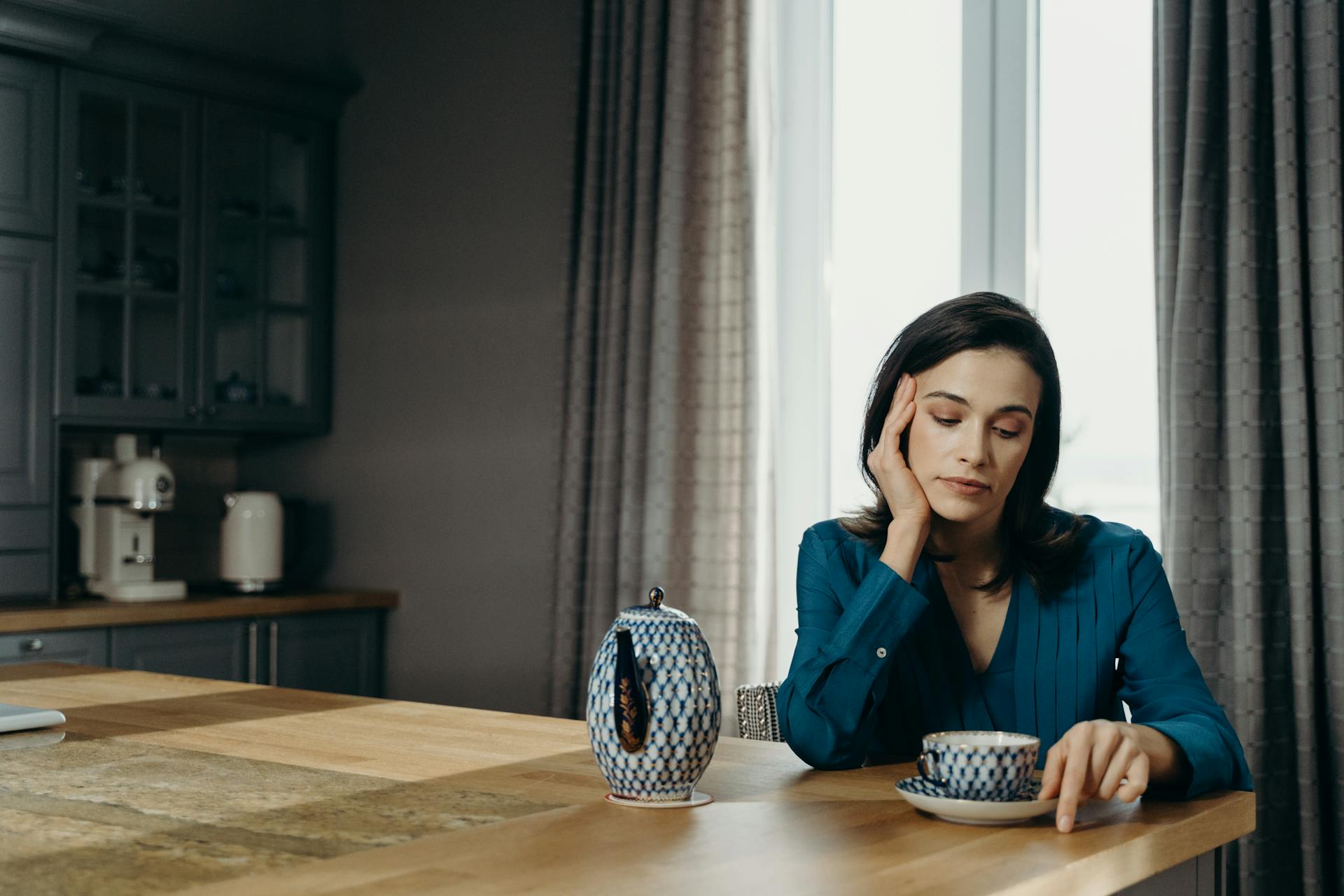 Eine nachdenkliche Frau beim Tee | Quelle: Pexels