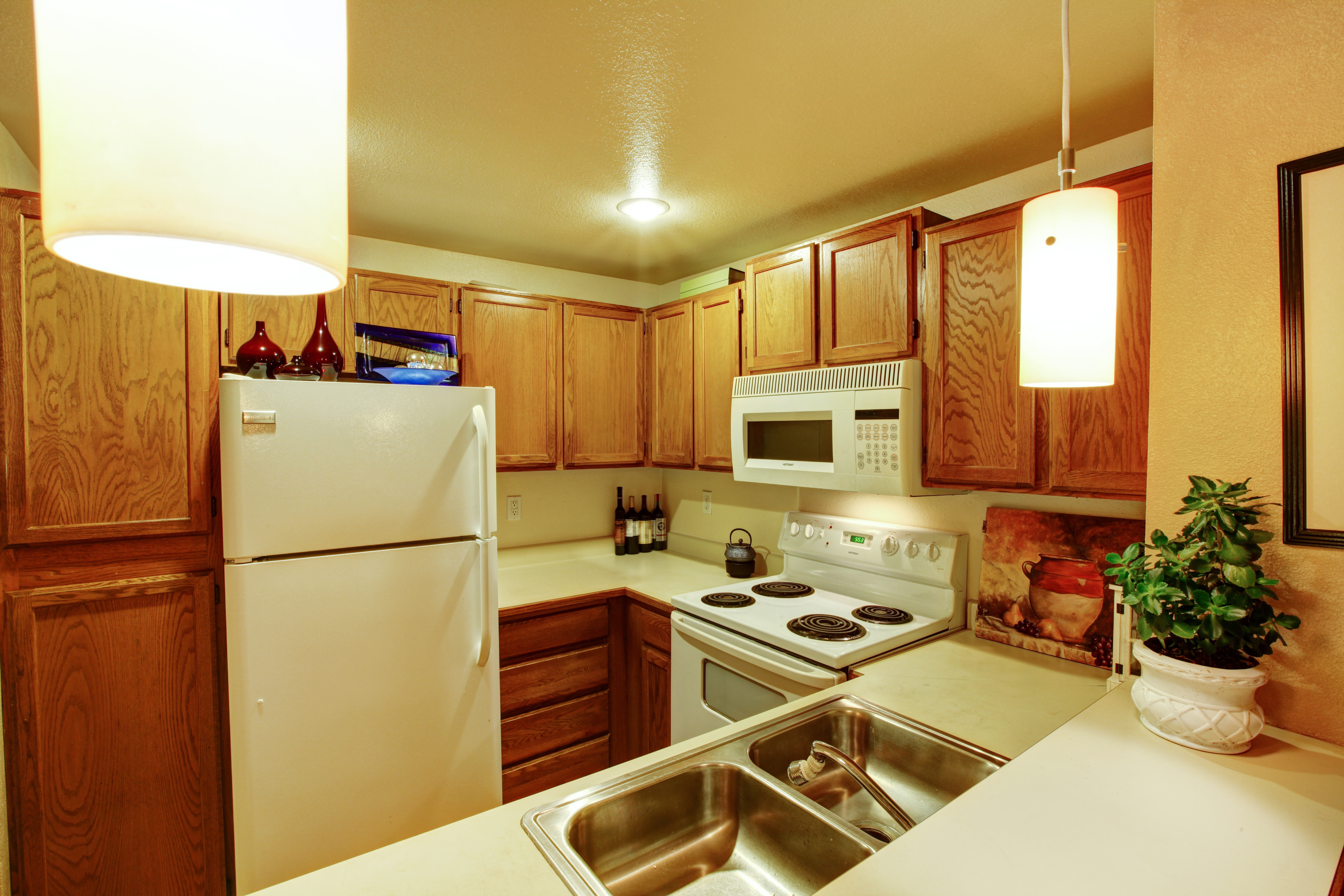 Ein Blick auf Küchenschränke mit Spüle und weißen Altgeräten | Quelle: Shutterstock