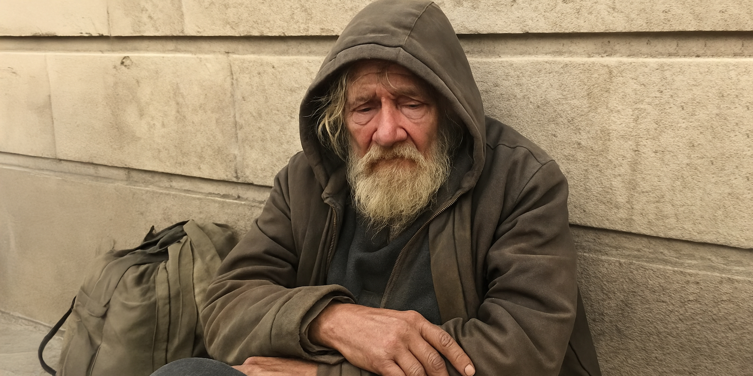 Obdachloser Mann sitzt auf der Straße | Quelle: Sora