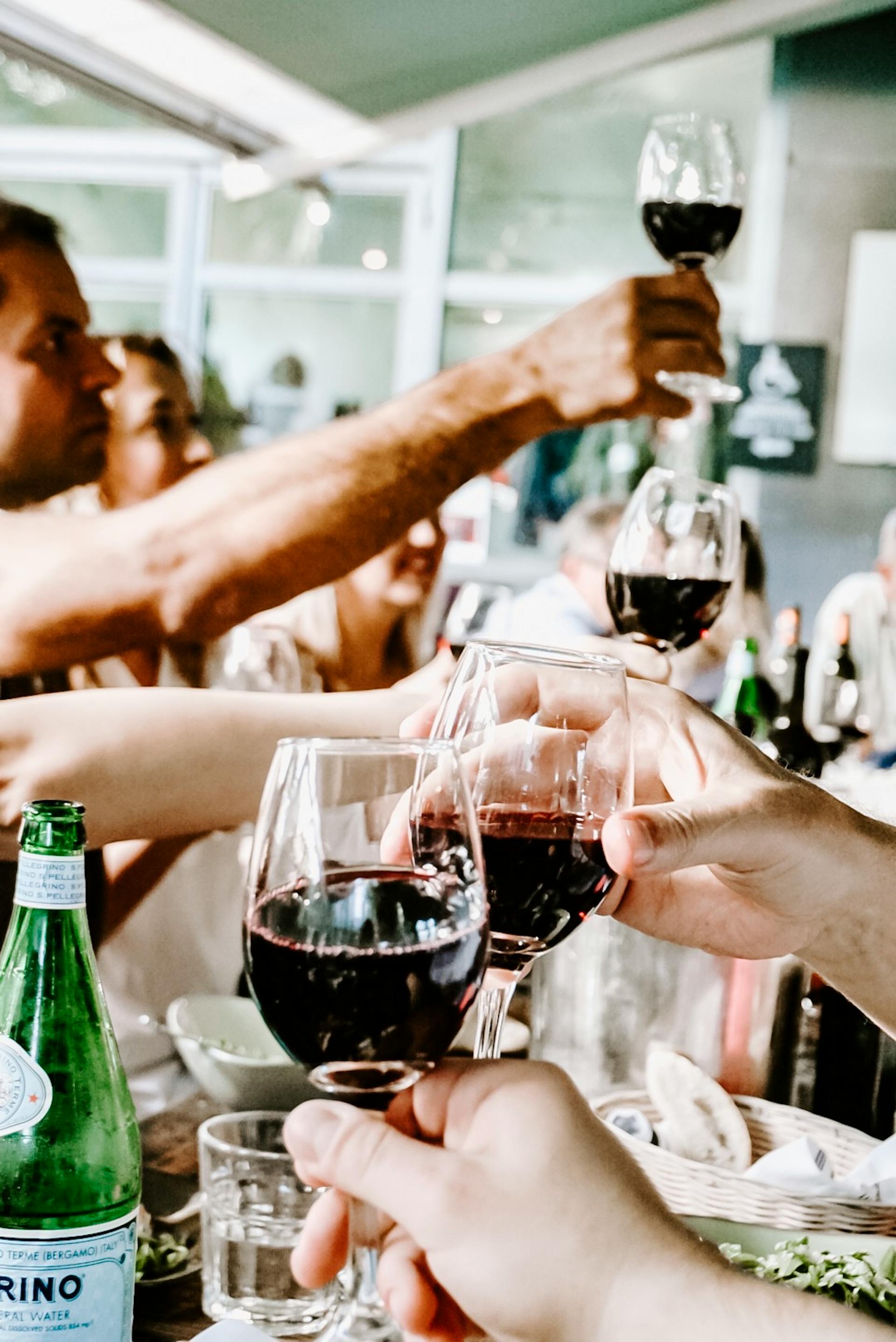 Eine Gruppe von Menschen stößt an | Quelle: Pexels