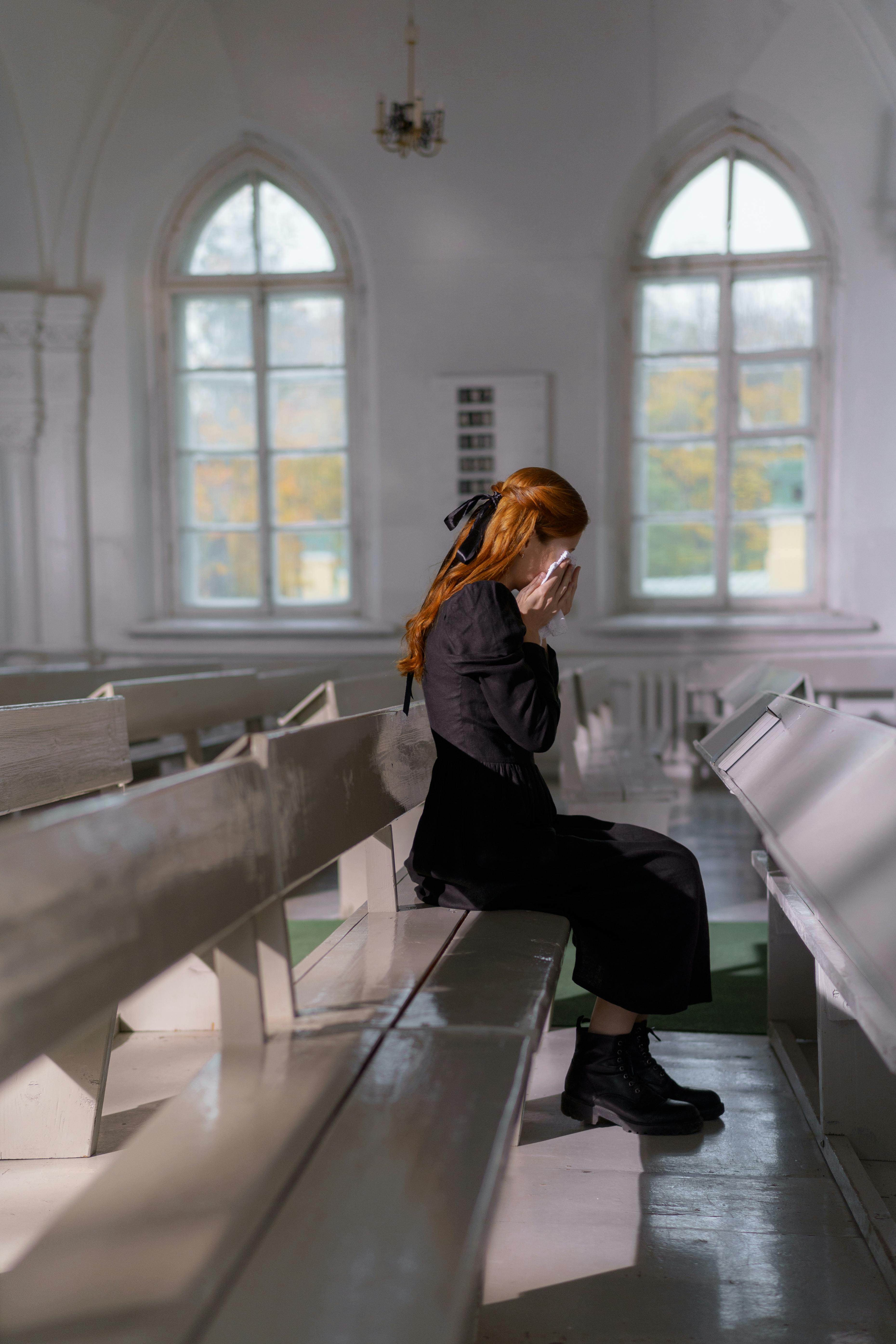 Eine weinende Frau in der Kirche | Quelle: Pexels