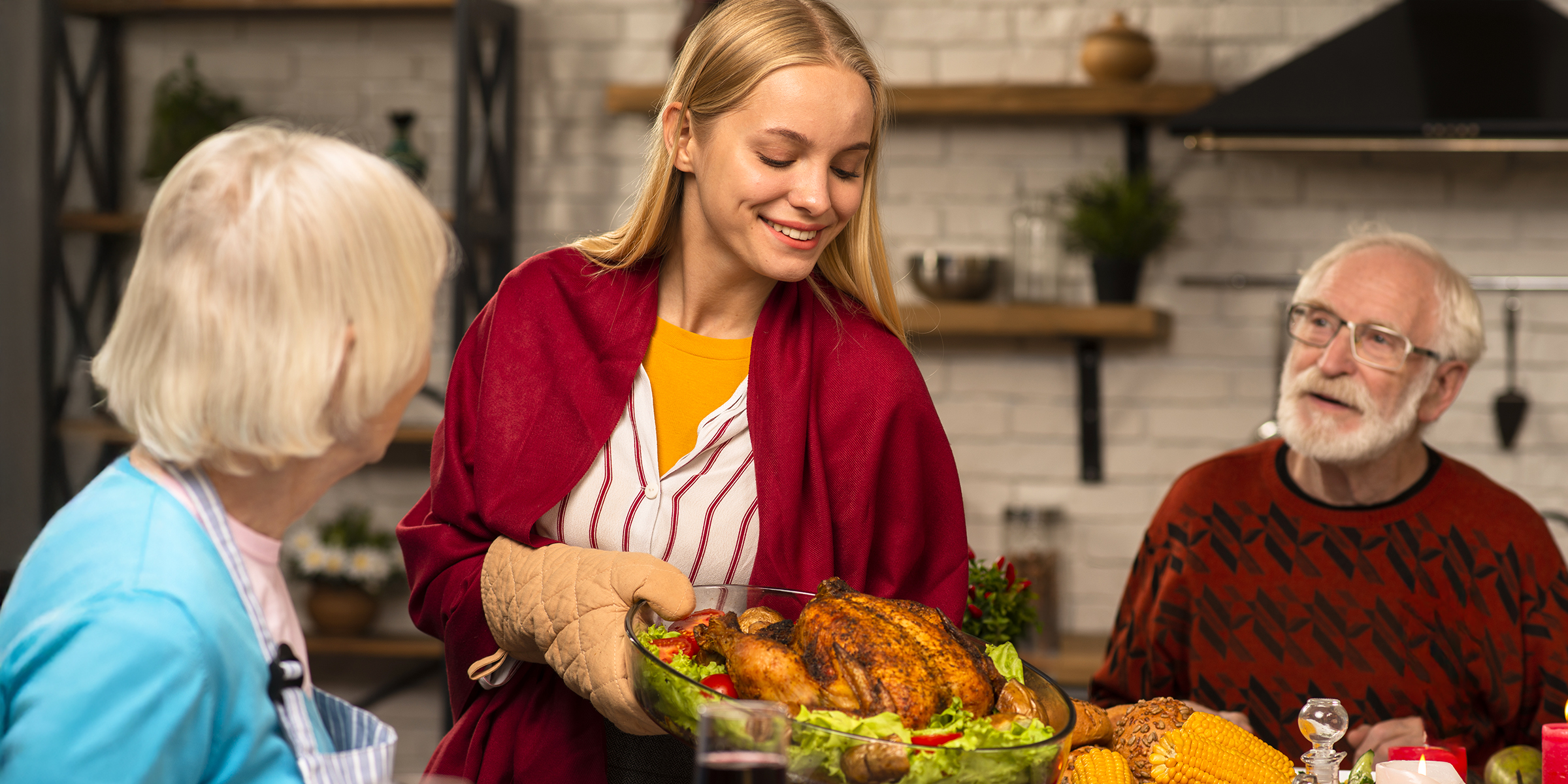 Eine Frau bedient ein älteres Ehepaar zu Thanksgiving | Quelle: Shutterstock