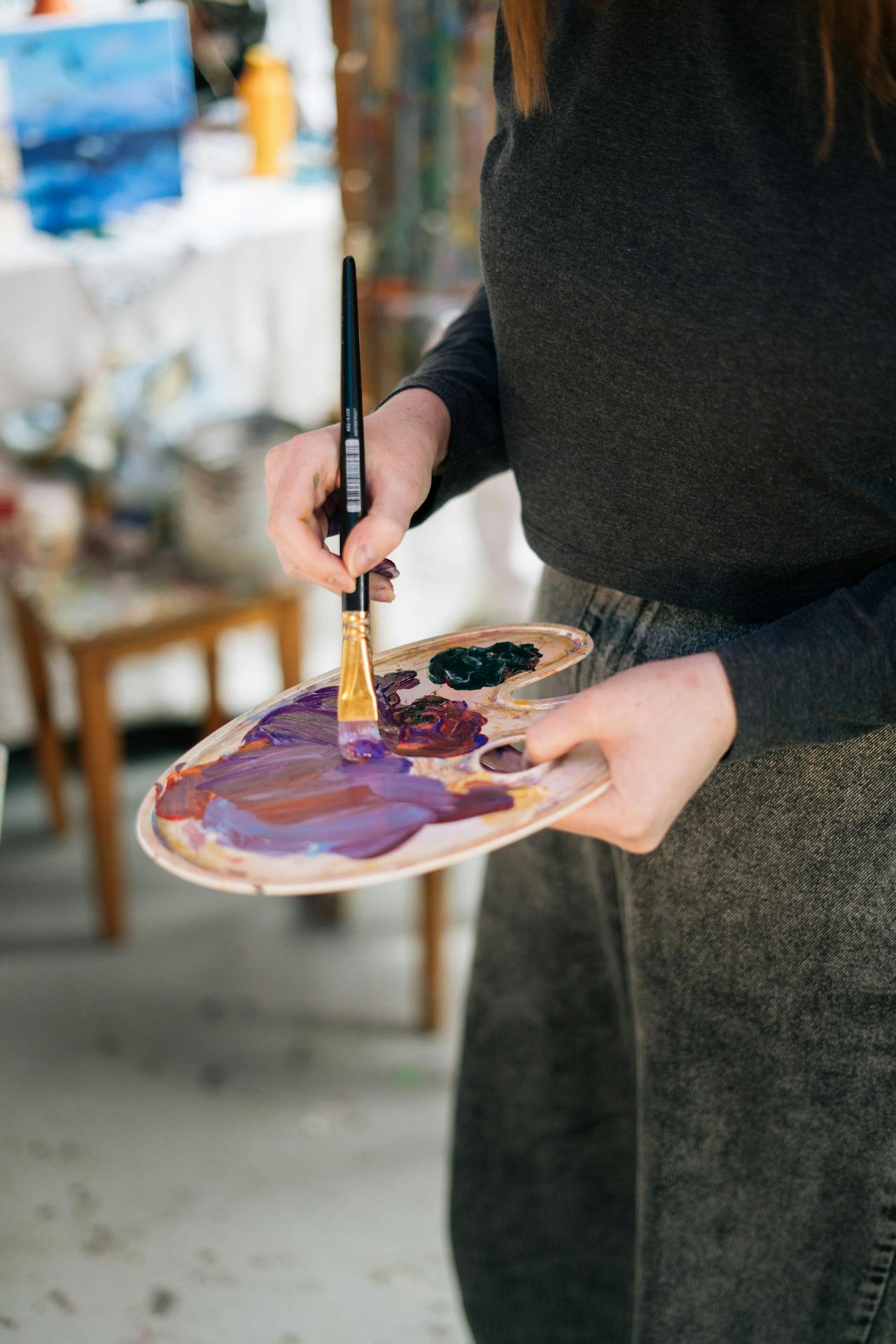 Eine Frau hält eine Farbpalette und einen Pinsel | Quelle: Pexels