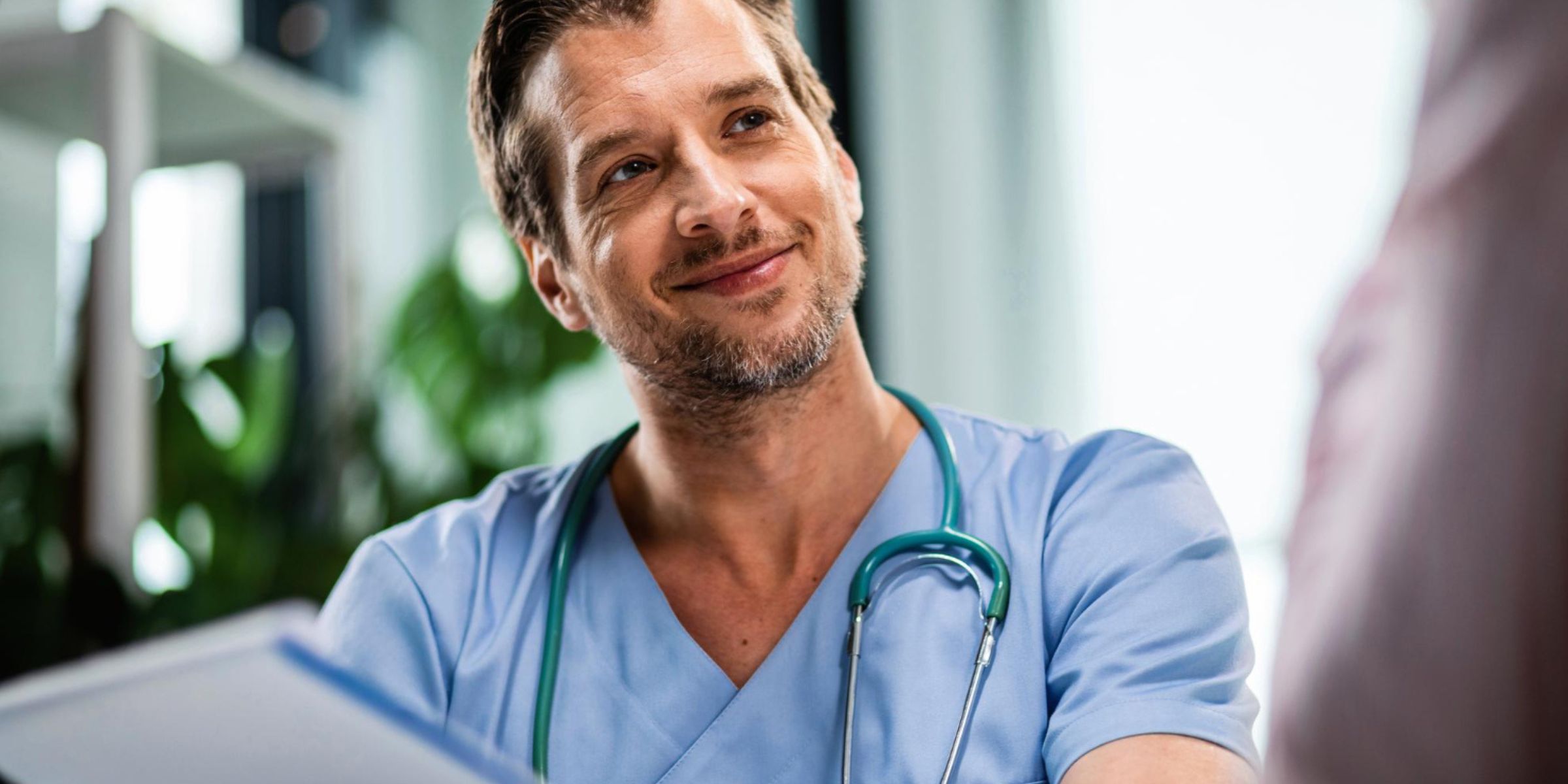 Ein Arzt im Gespräch mit einem Patienten während einer Sprechstunde | Quelle: Magnific