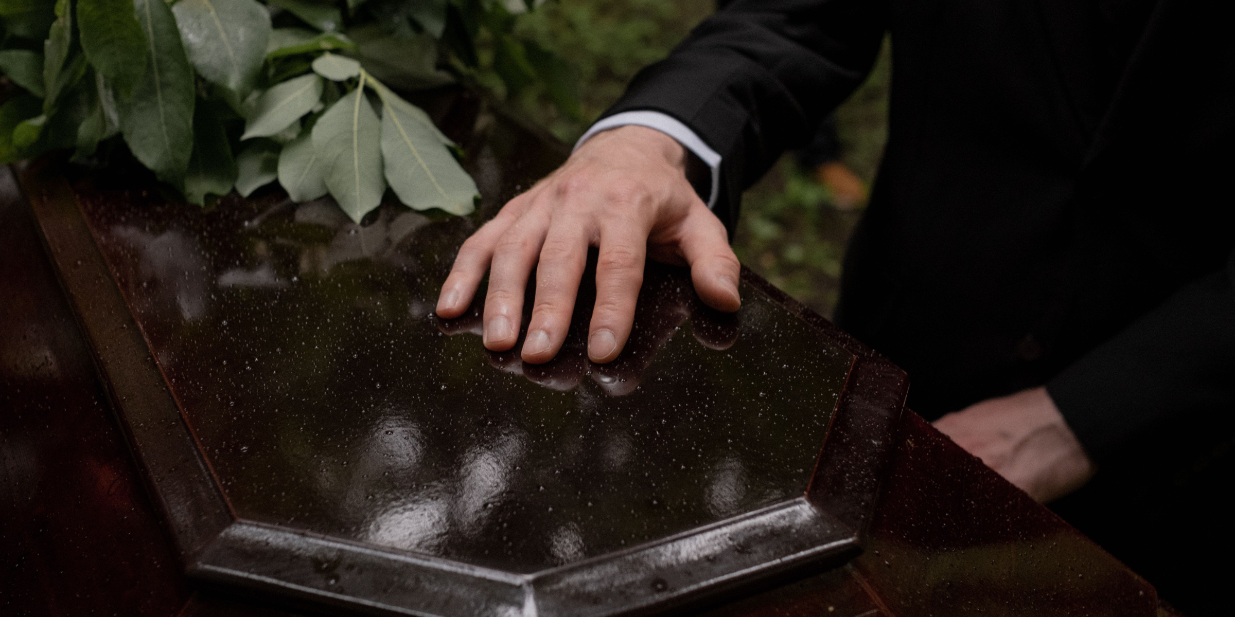 Eine Hand auf einem Sarg | Quelle: Pexels