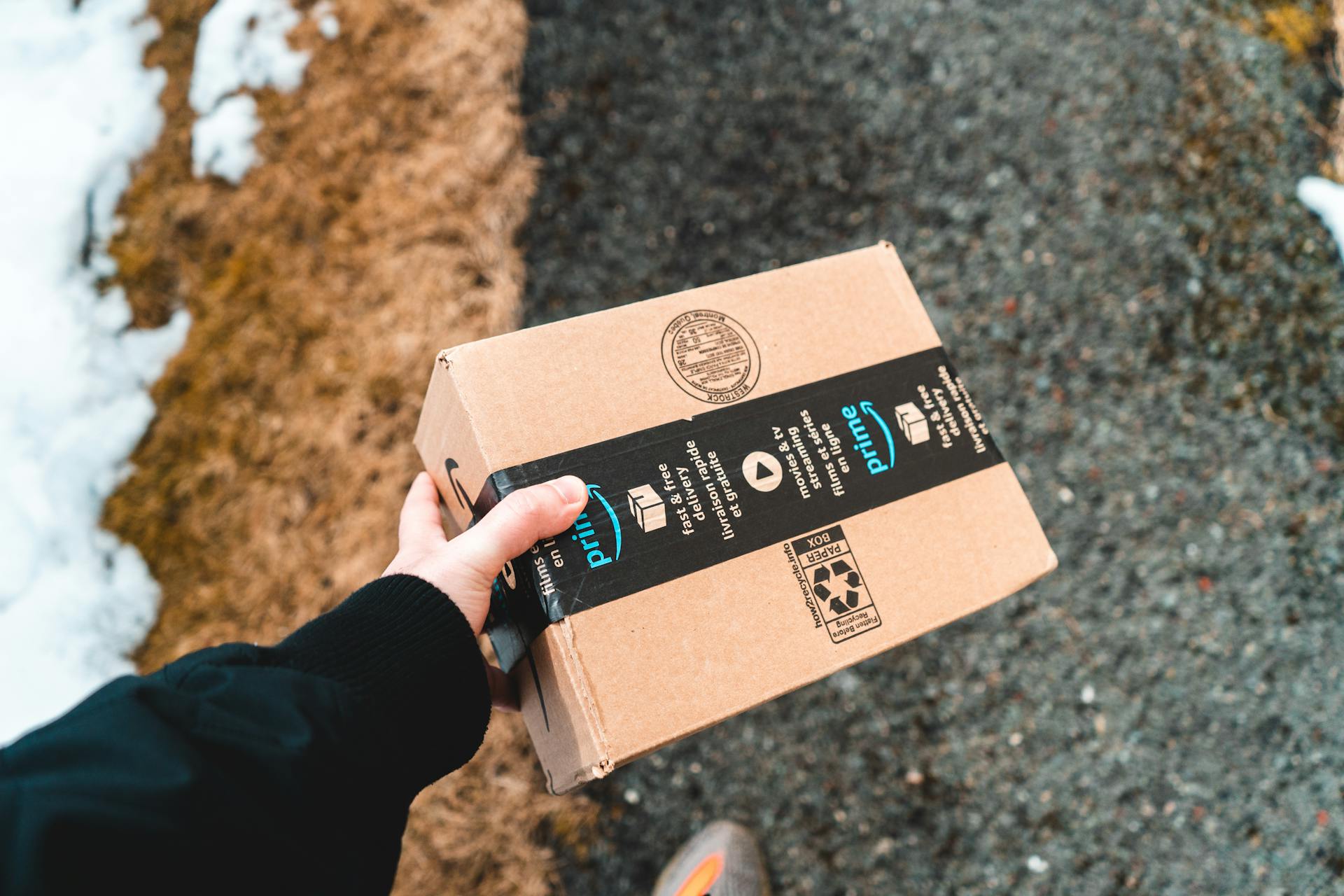 Eine Person, die ein Amazon-Paket hält | Quelle: Pexels