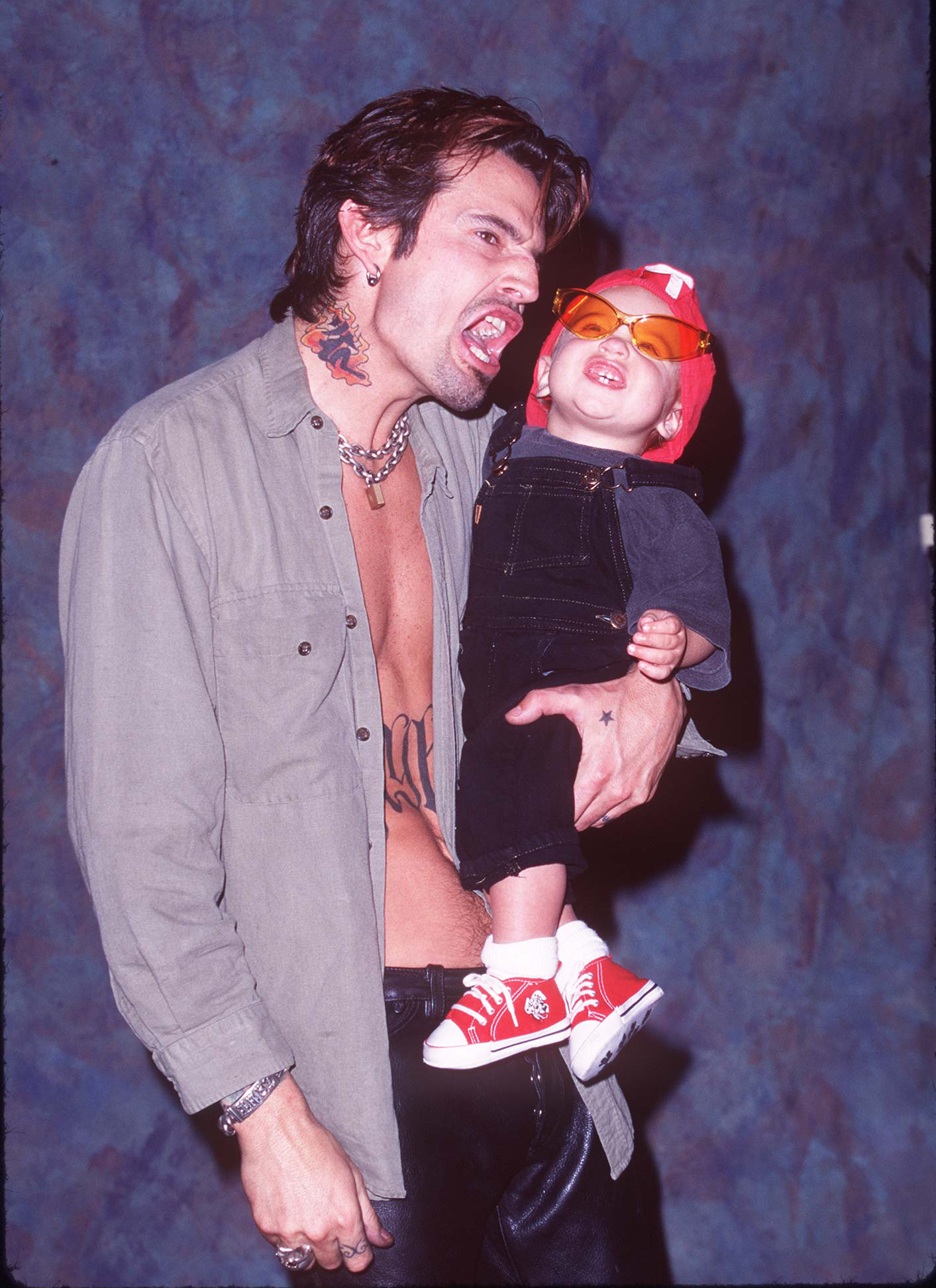 Tommy Lee reagiert, während er seinen Sohn Brandon im Guitar Center in Hollywood, Kalifornien, am 20. Mai 1997 im Arm hält | Quelle: Getty Images