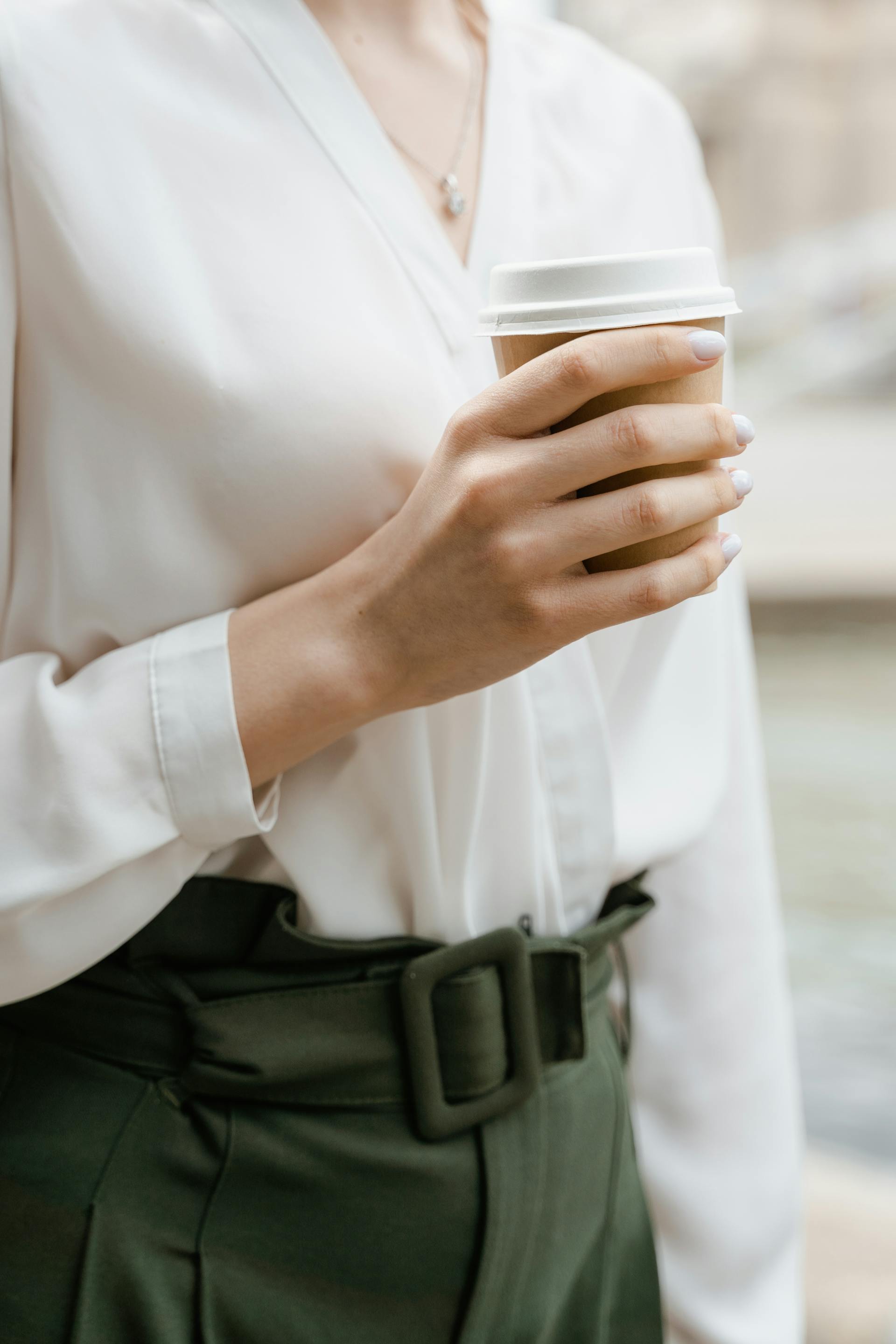 Eine Nahaufnahme einer Frau mit Kaffee in der Hand | Quelle: Pexels