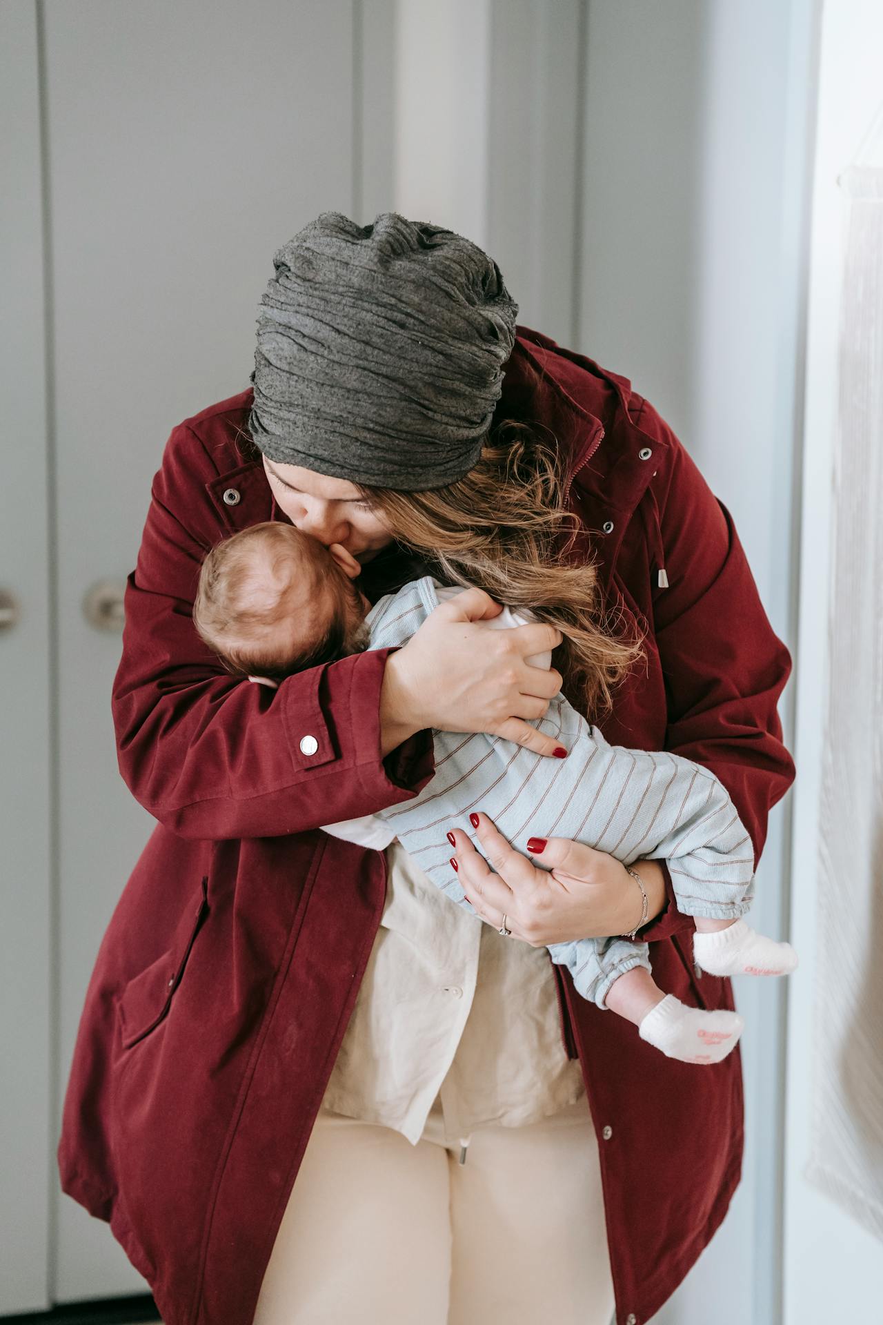 Eine Mutter küsst ihr Baby auf die Stirn | Quelle: Pexels