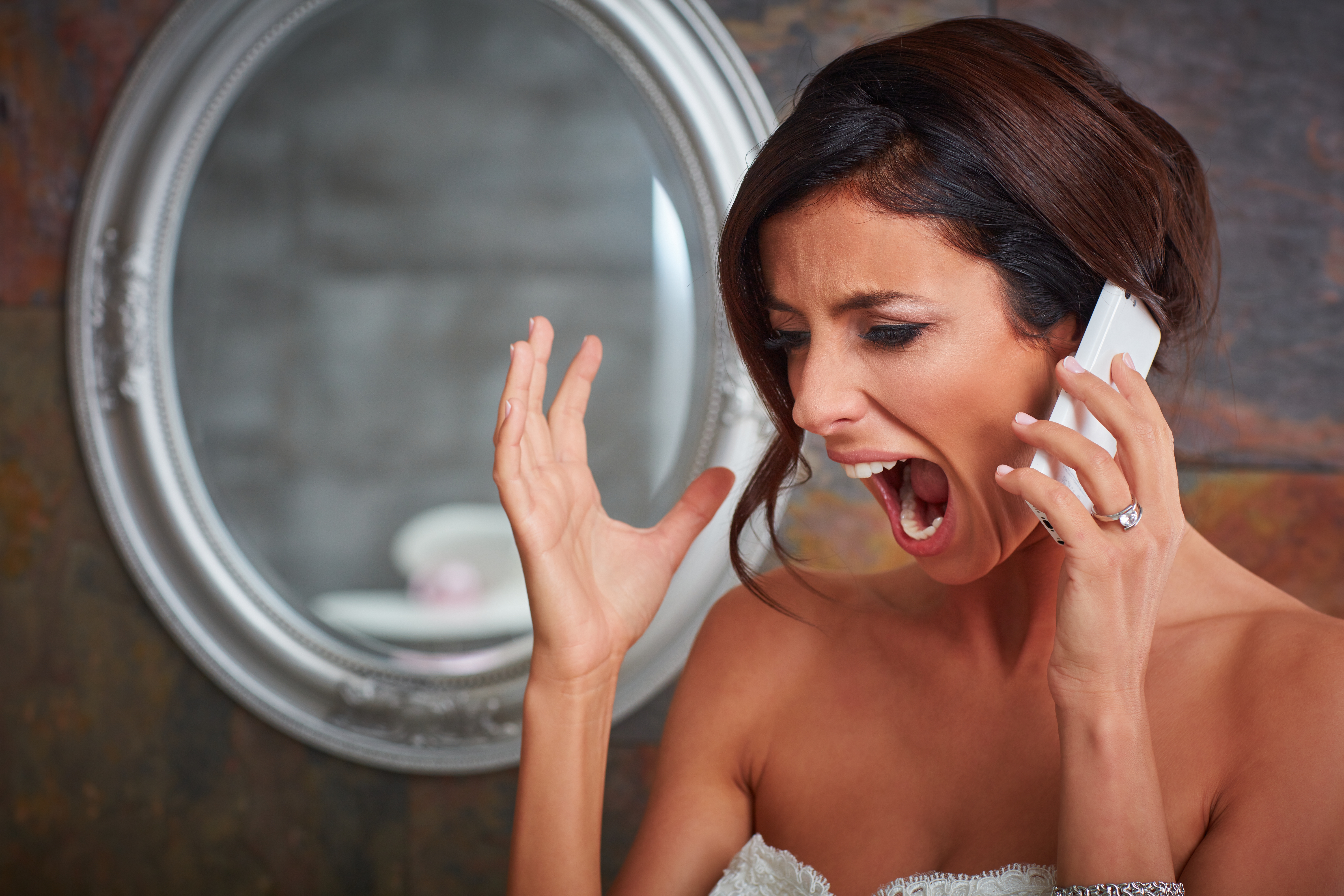 Eine schreiende Braut, während sie telefoniert | Quelle: Shutterstock