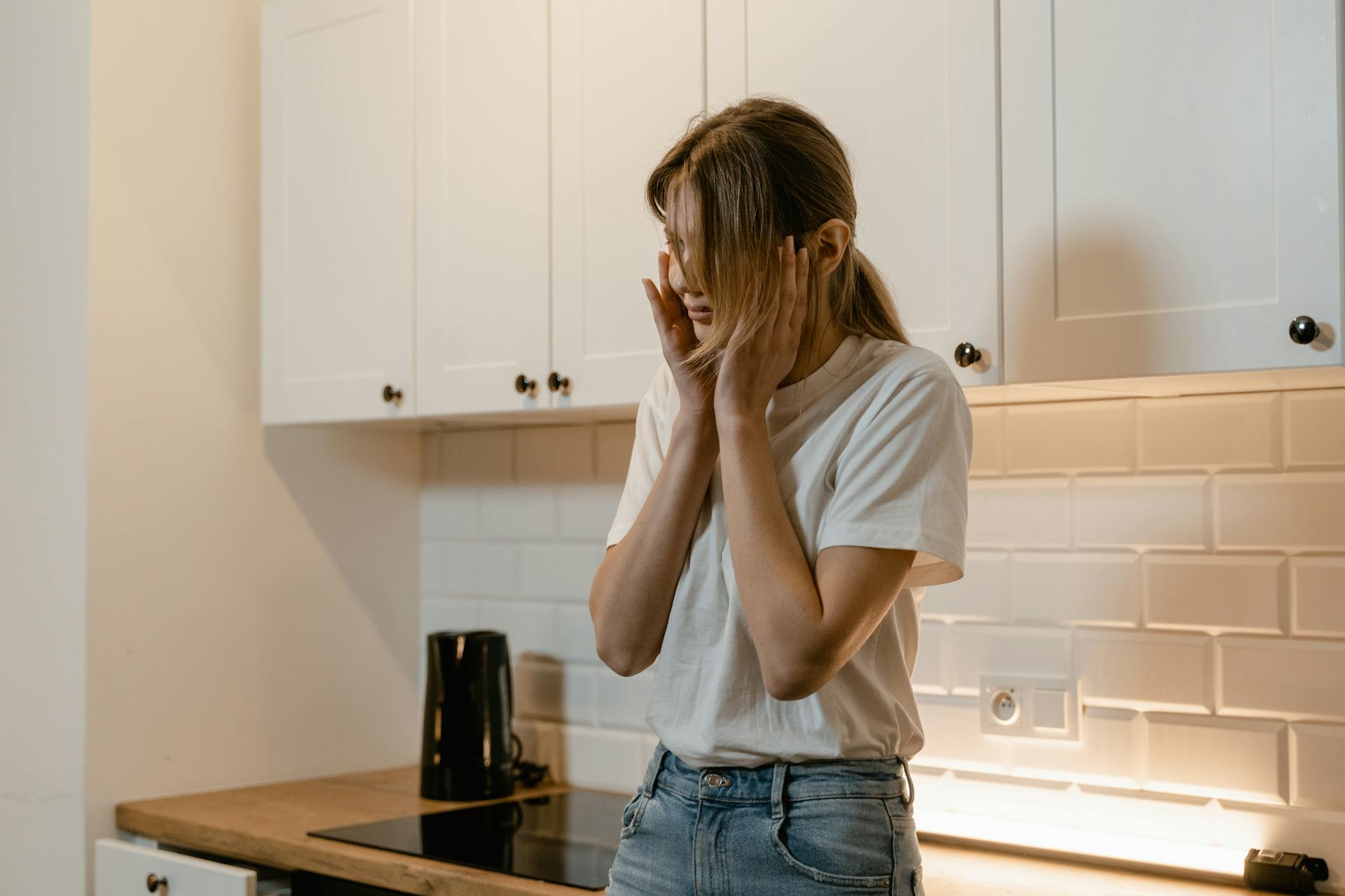 Eine besorgt dreinblickende Frau in einer Küche | Quelle: Pexels