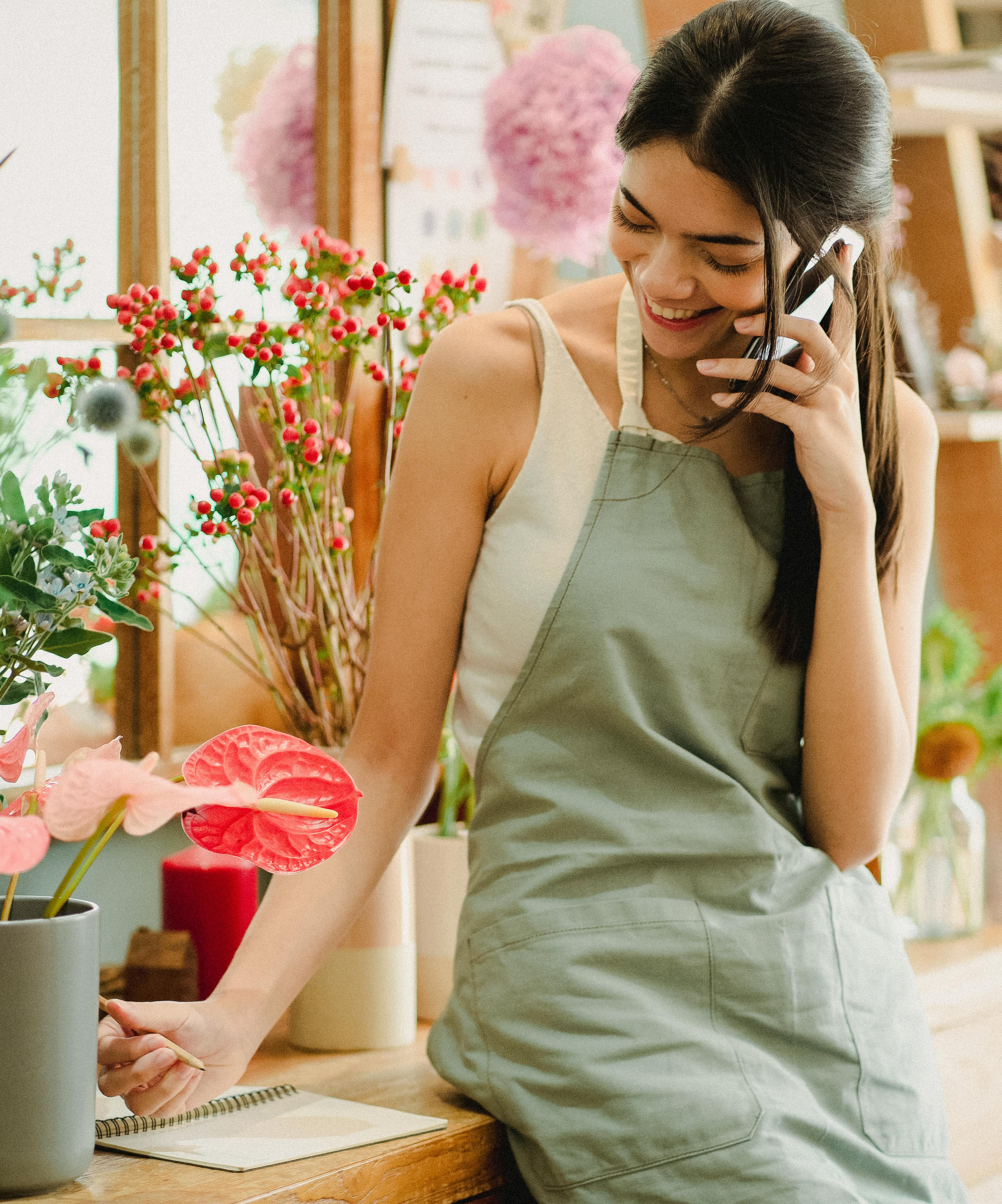 Eine glückliche junge Frau, die mit jemandem telefoniert | Quelle: Pexels