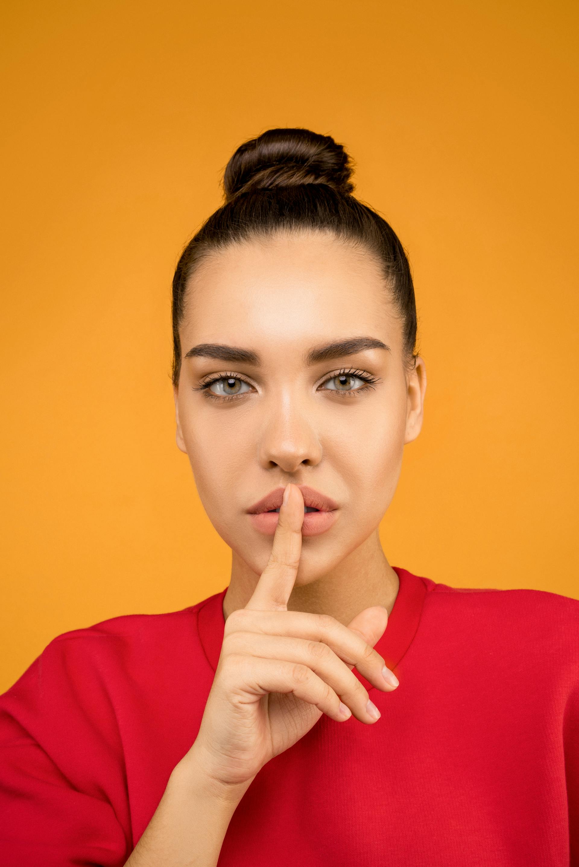 Eine Frau, die einen Finger an ihre Lippen legt | Quelle: Pexels