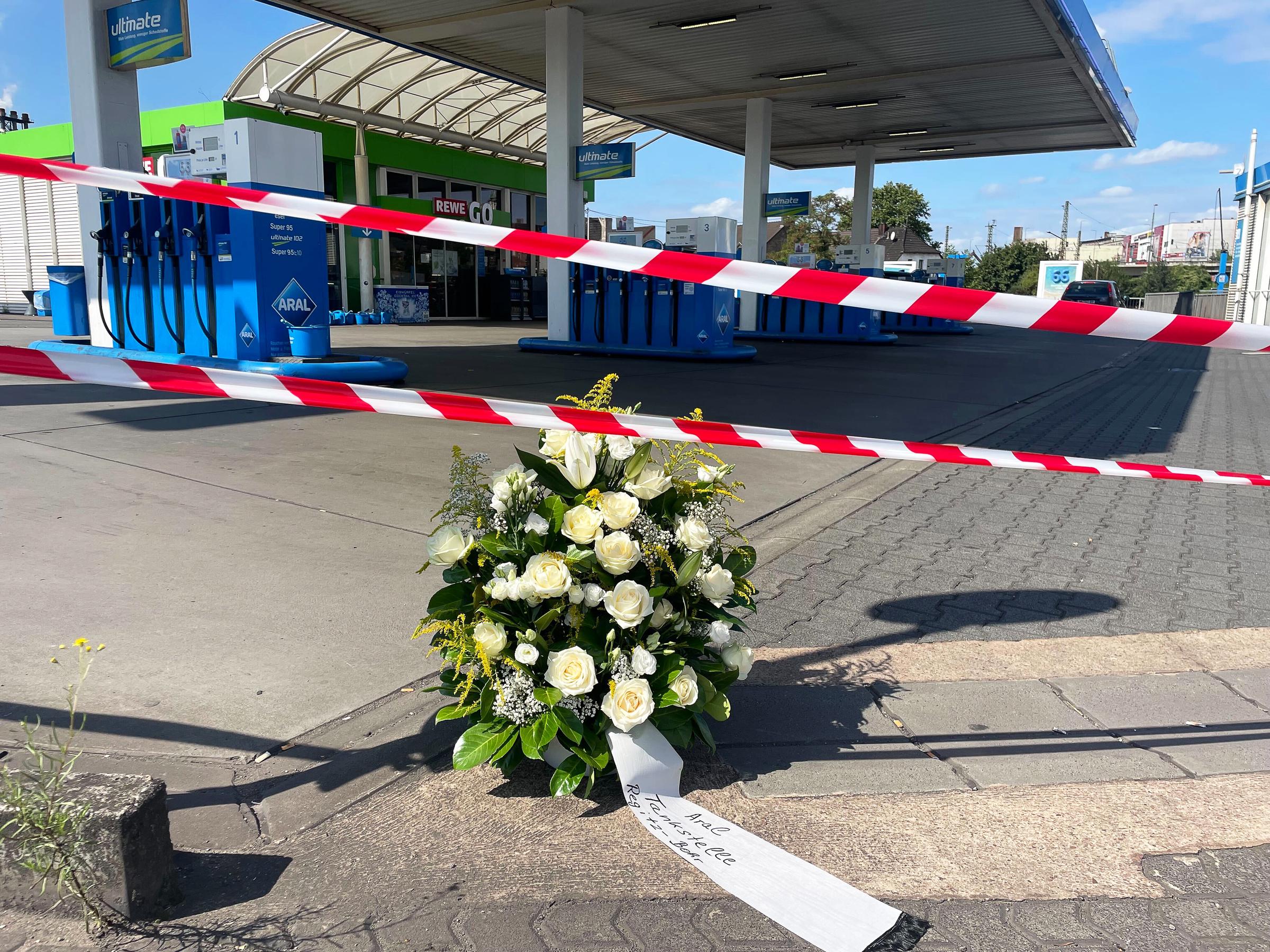 22. August 2025, Saarland, Völklingen: Mitarbeiter haben an der Tankstelle, an der ein Polizist nach einem Raubüberfall getötet wurde, einen Kranz niedergelegt. | Quelle: Getty Images