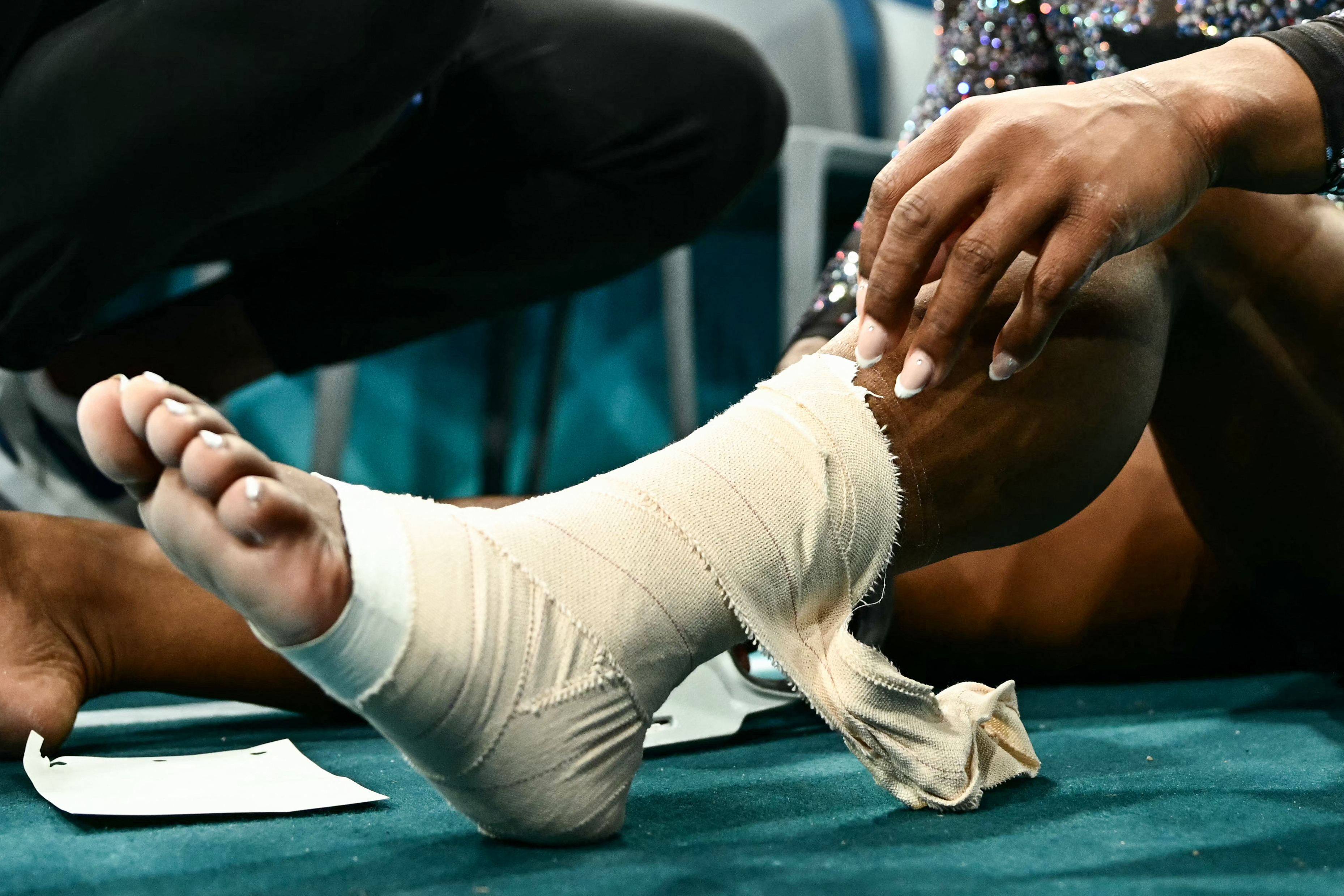 Eine Nahaufnahme von Simone Biles' bandagiertem Knöchel und Wade während der Qualifikation im Kunstturnen der Frauen in Paris, Frankreich am 28. Juli 2024 | Quelle: Getty Images