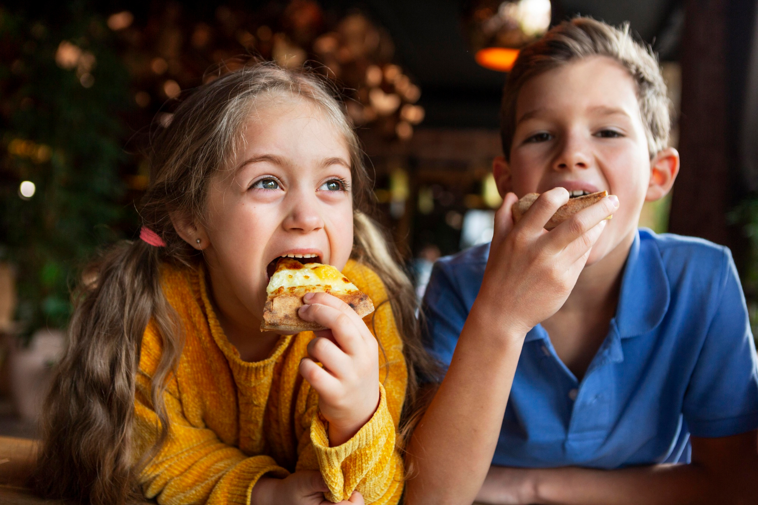 Aufgeregte Kinder essen Pizza | Quelle: Freepik