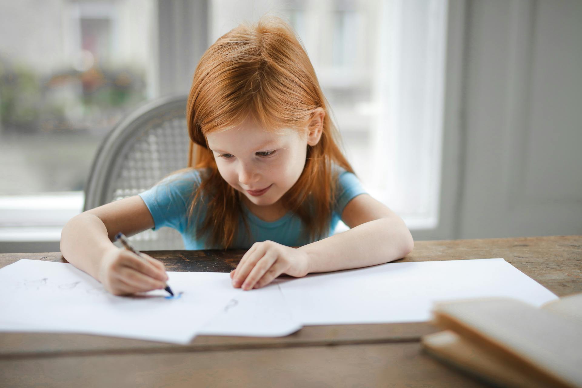 Ein Kind, das am Tisch sitzt und malt | Quelle: Pexels