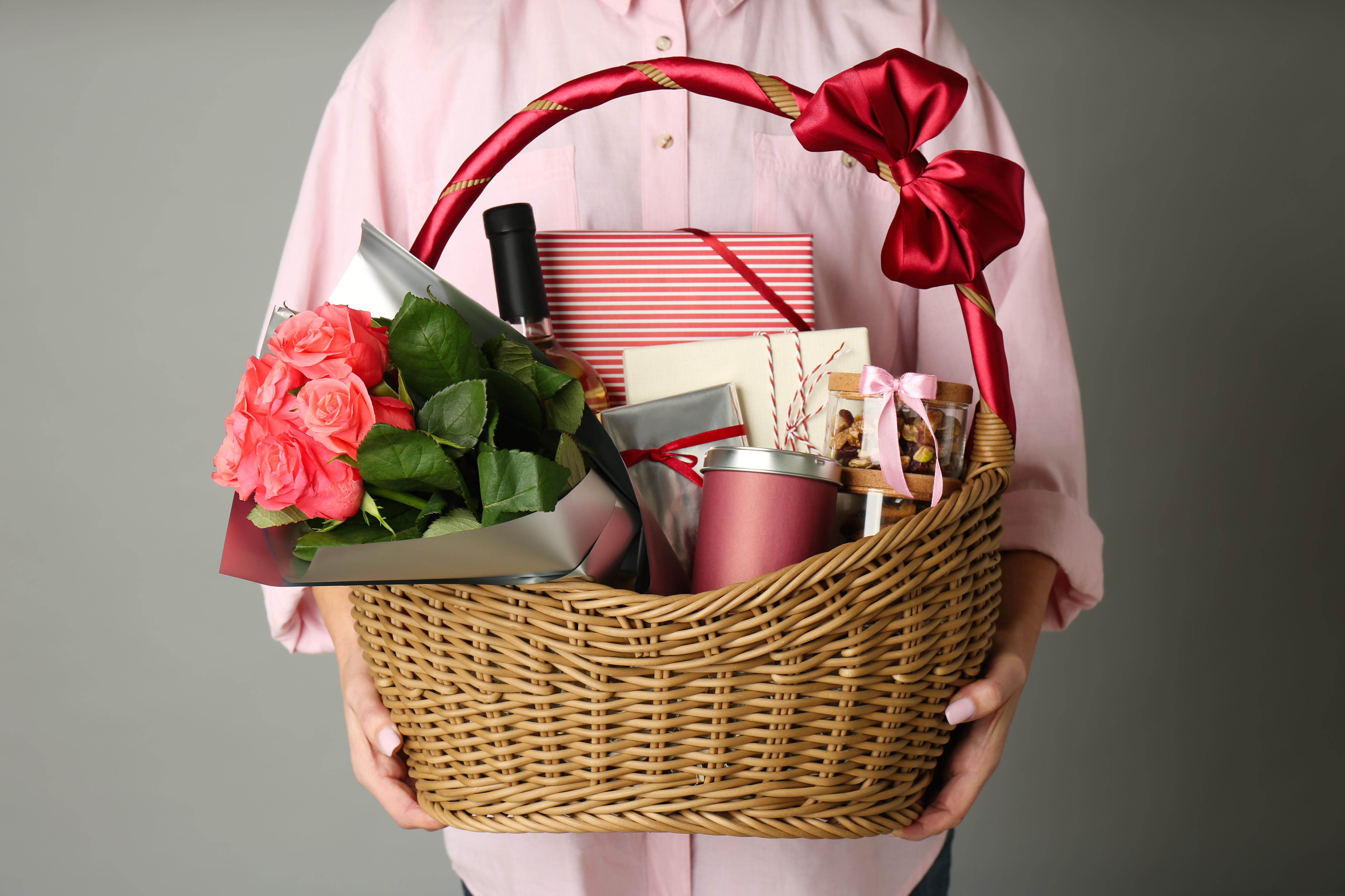 Person mit Weidenkorb voller Geschenke | Quelle: Shutterstock