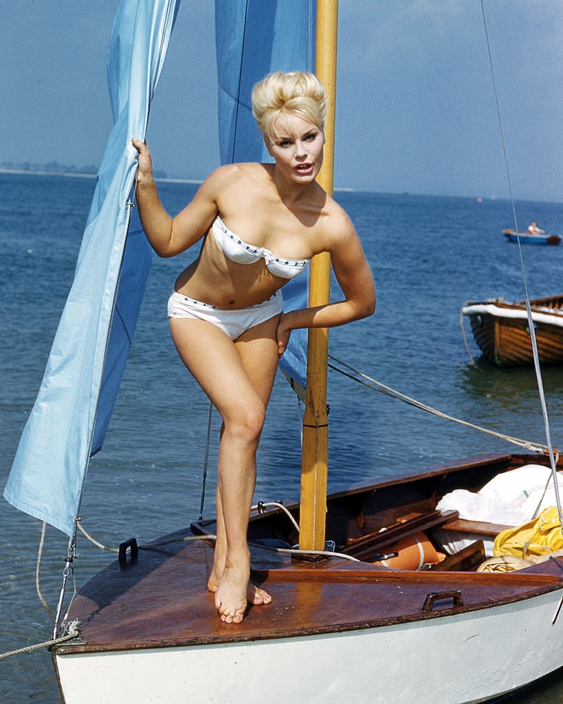 German actress Elke Sommer wearing a bikini and standing on the deck of a sailing dinghy, circa 1963. (Photo by Silver Screen Collection/Getty Images)