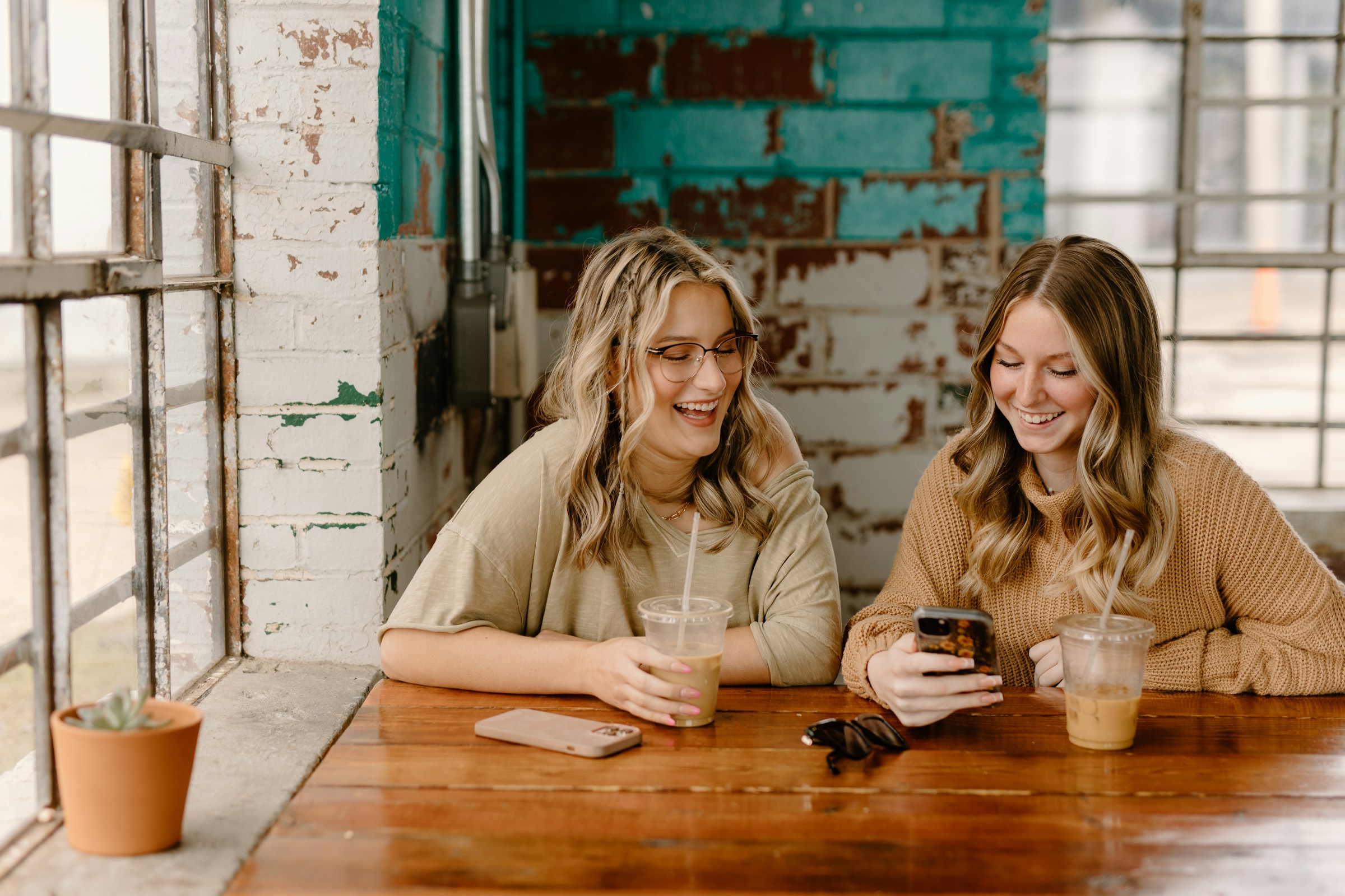 Freunde beim Kaffee trinken und lächeln | Quelle: Unsplash