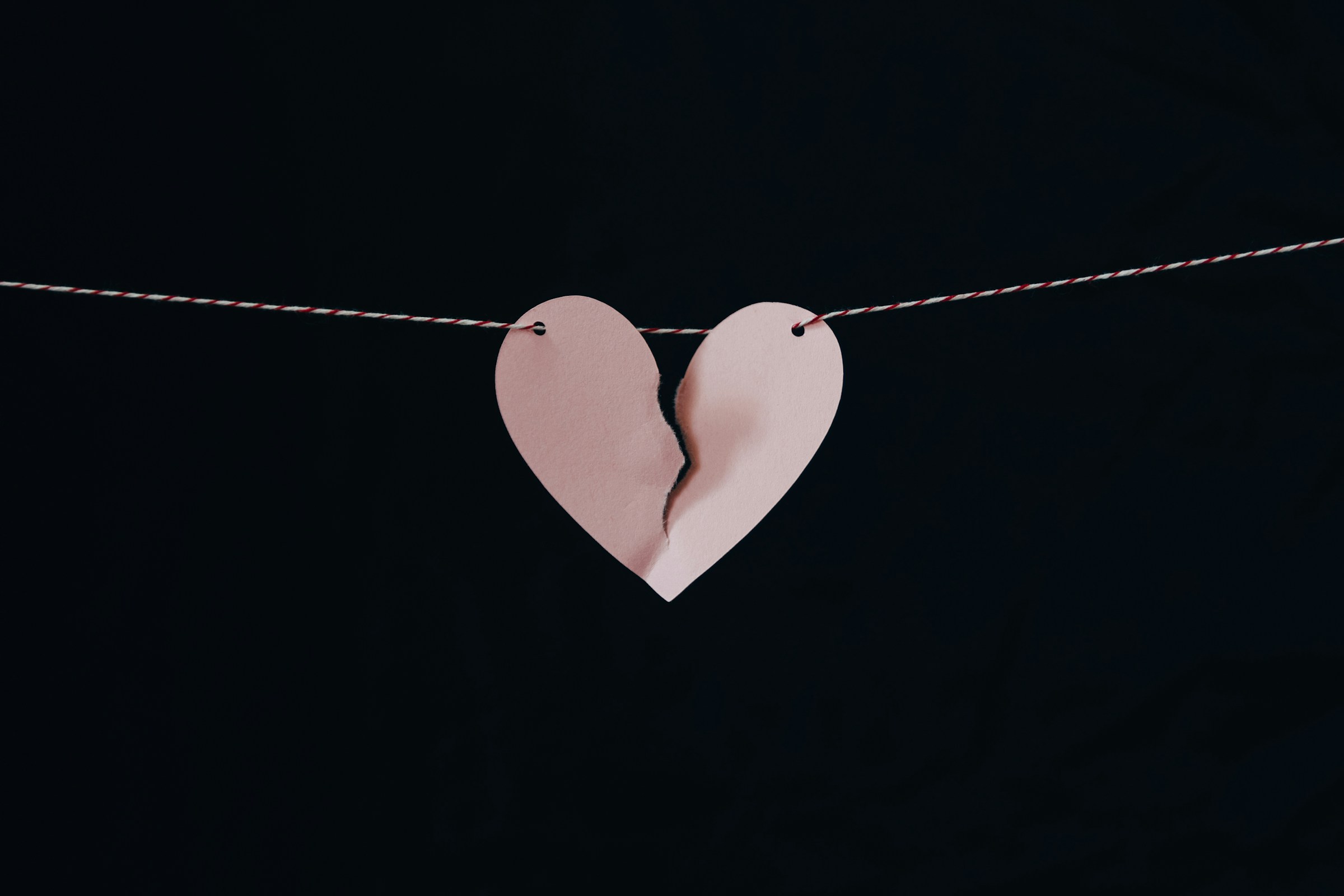 Ein gebrochenes Herz hängt an einem Draht | Quelle: Pexels