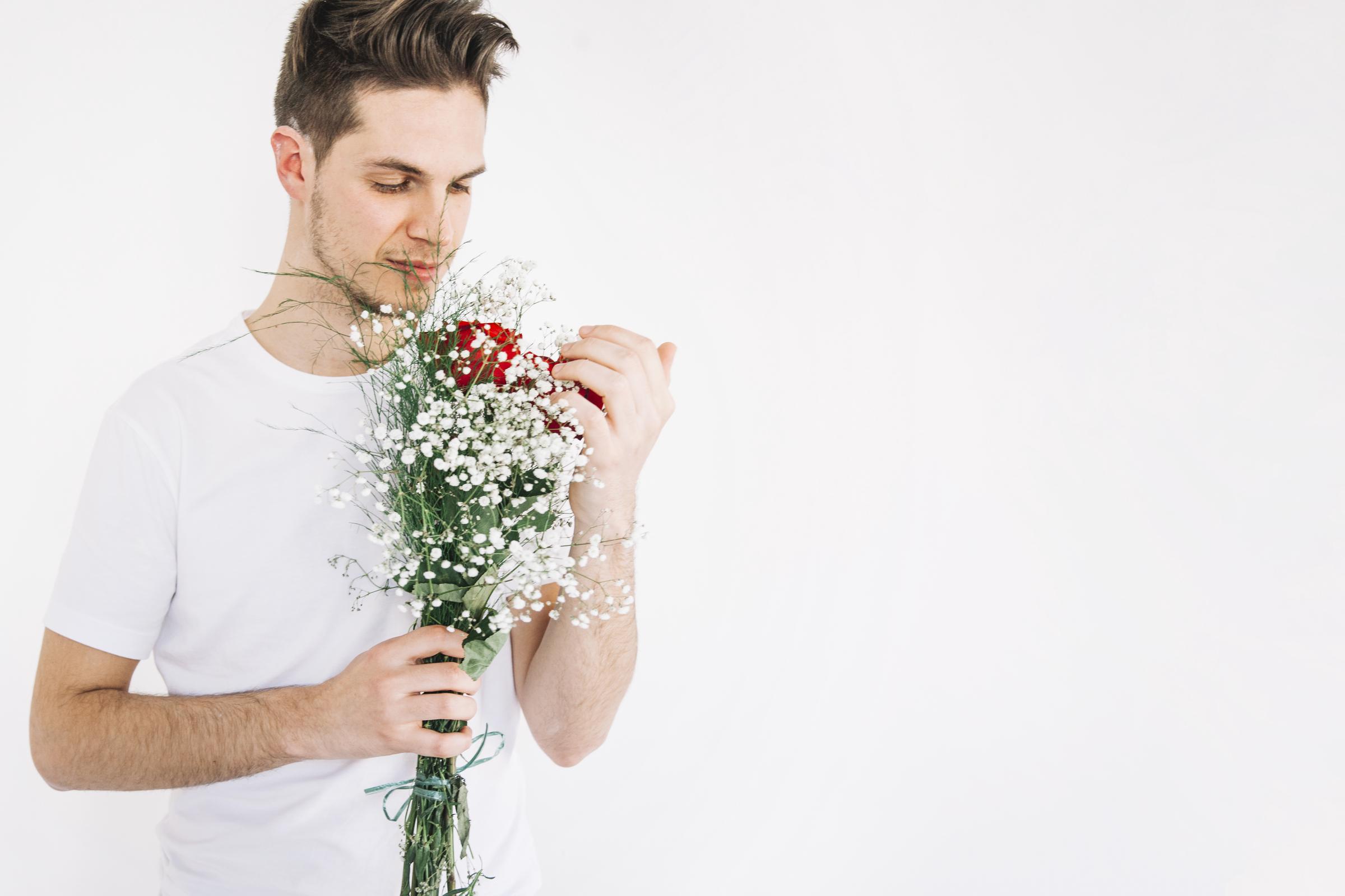 Ein junger Mann mit Blumen | Quelle: Freepik