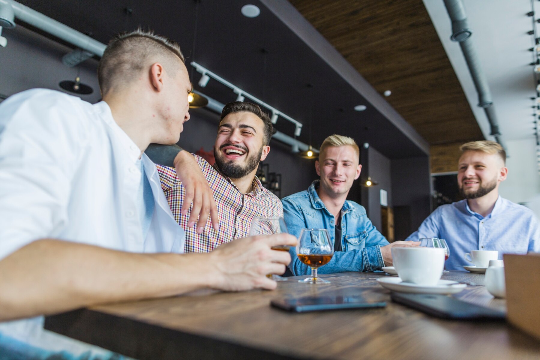 Lachende Männer in einem Restaurant | Quelle: Pexels