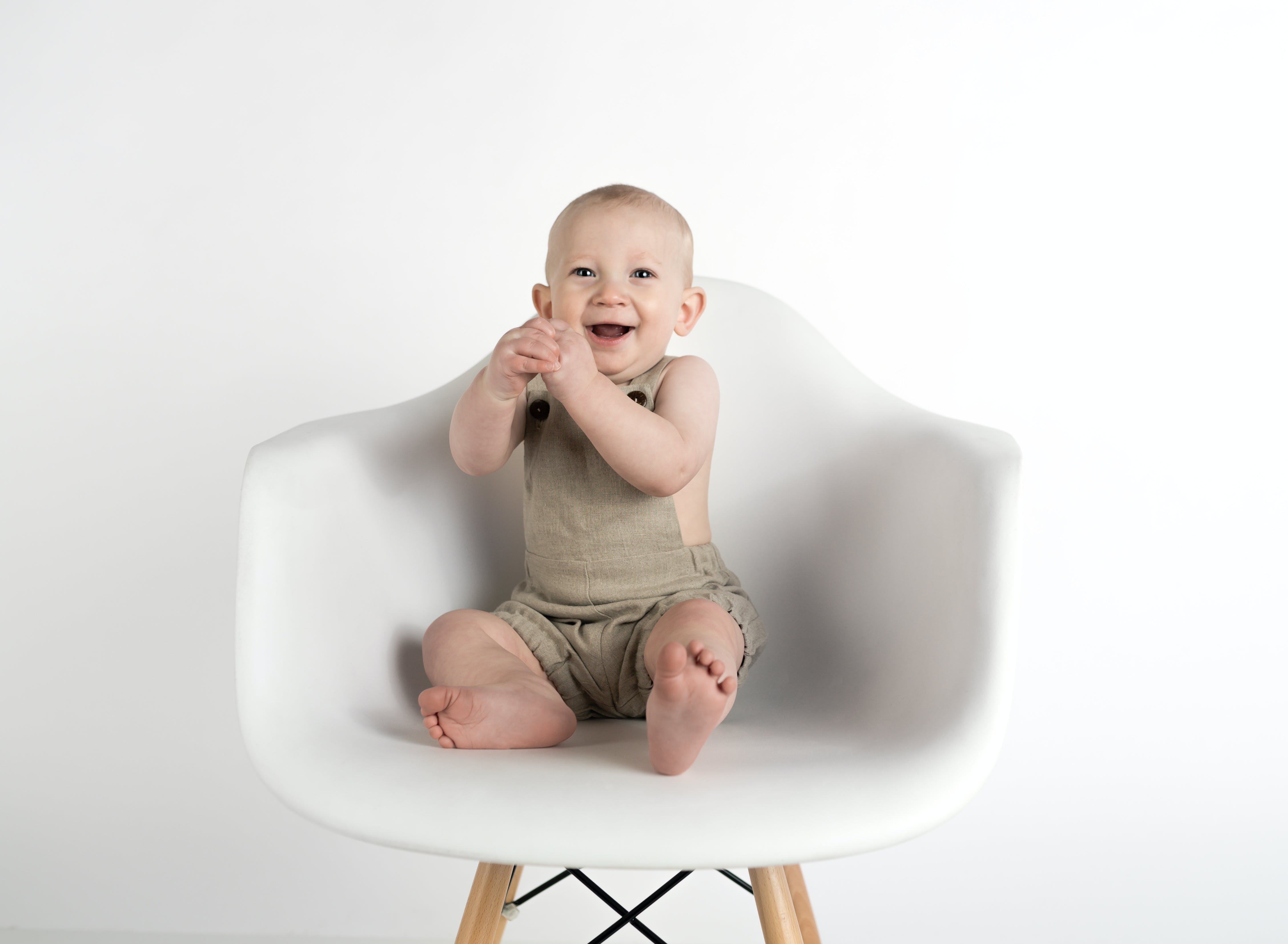 Ein lachendes Baby, das auf einem Stuhl sitzt | Quelle: Pexels